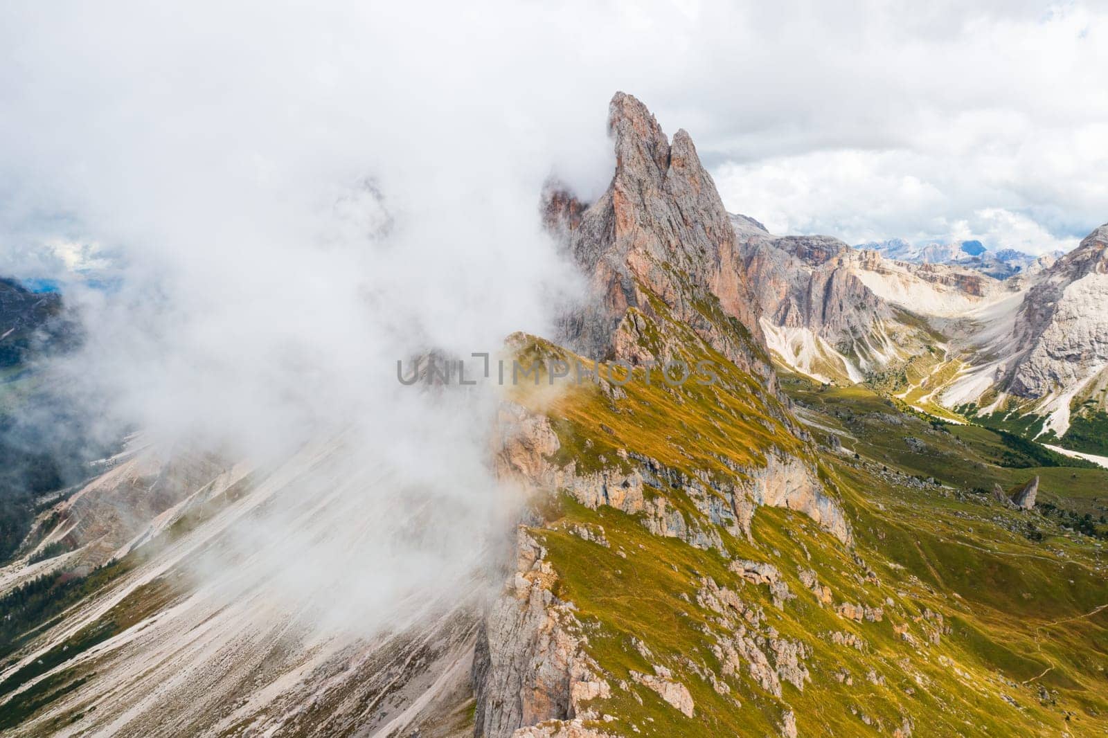 Heavy clouds hover over Seceda mountain range in Alps by vladimka