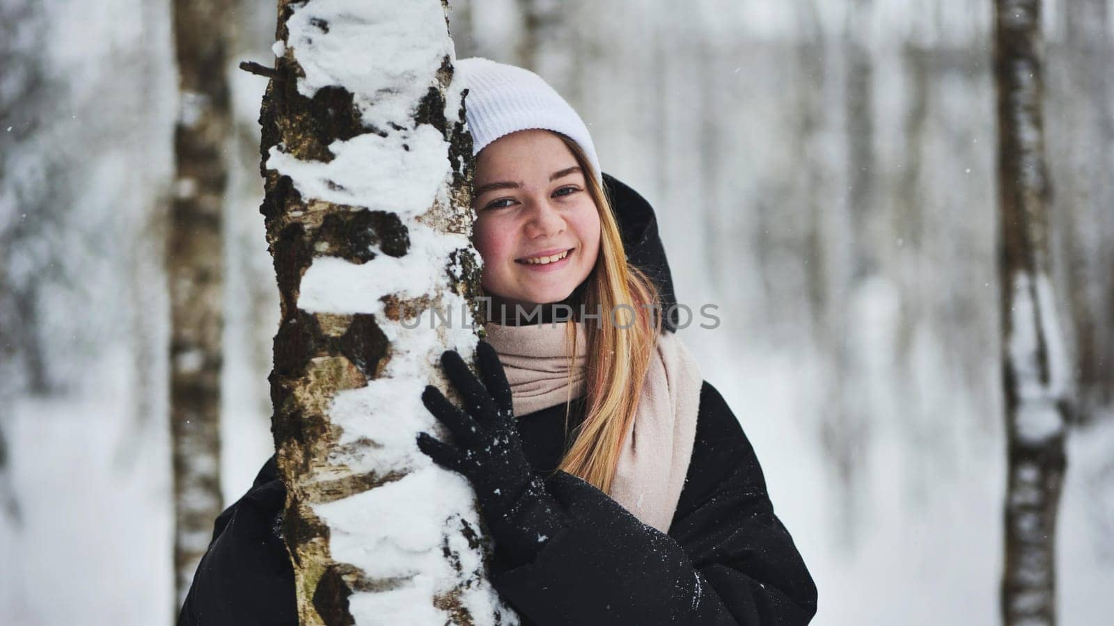 Portrait of a girl in winter in a birch forest