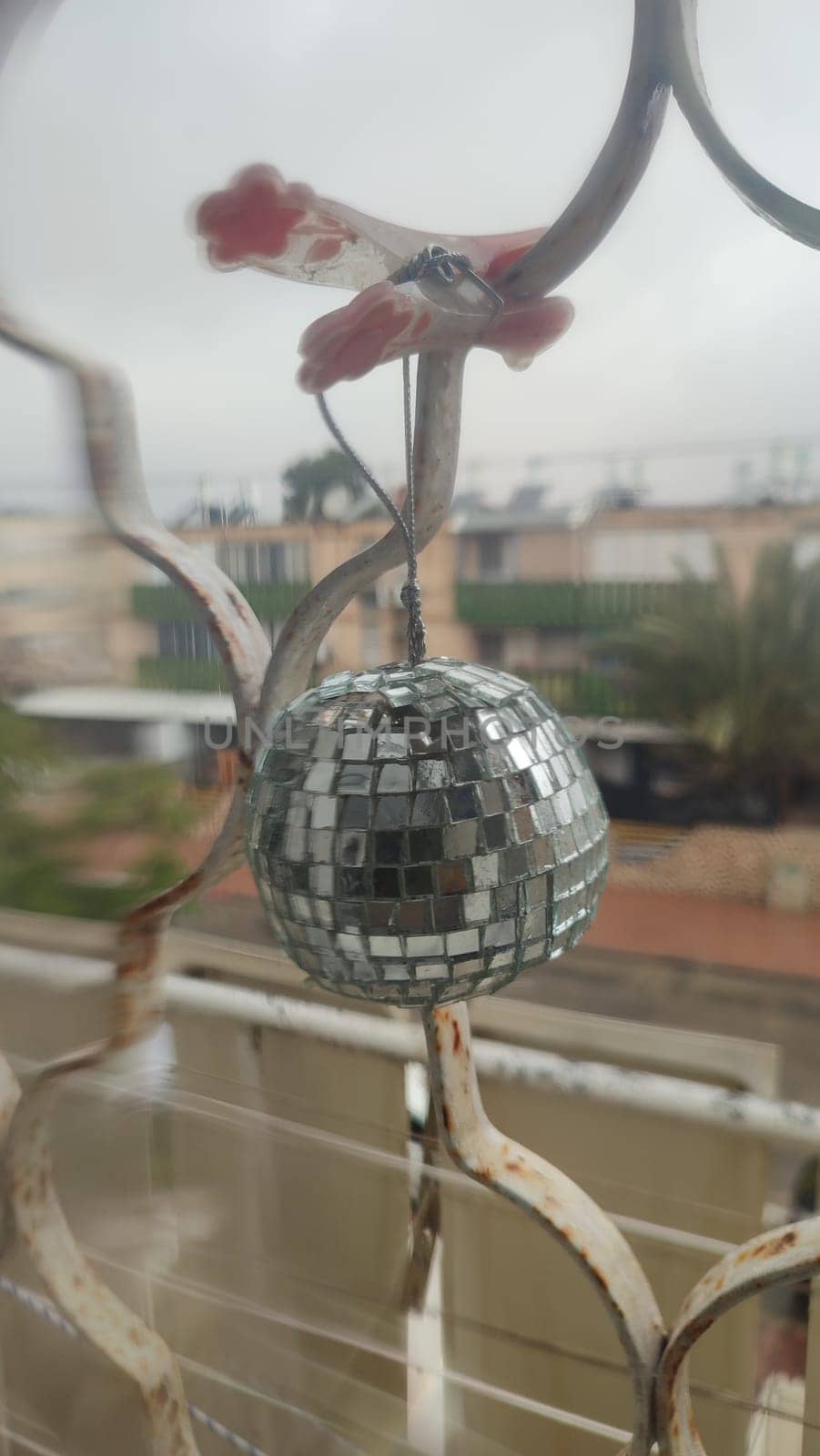 round shiny mirror ball hanging on the window, objects. High quality photo
