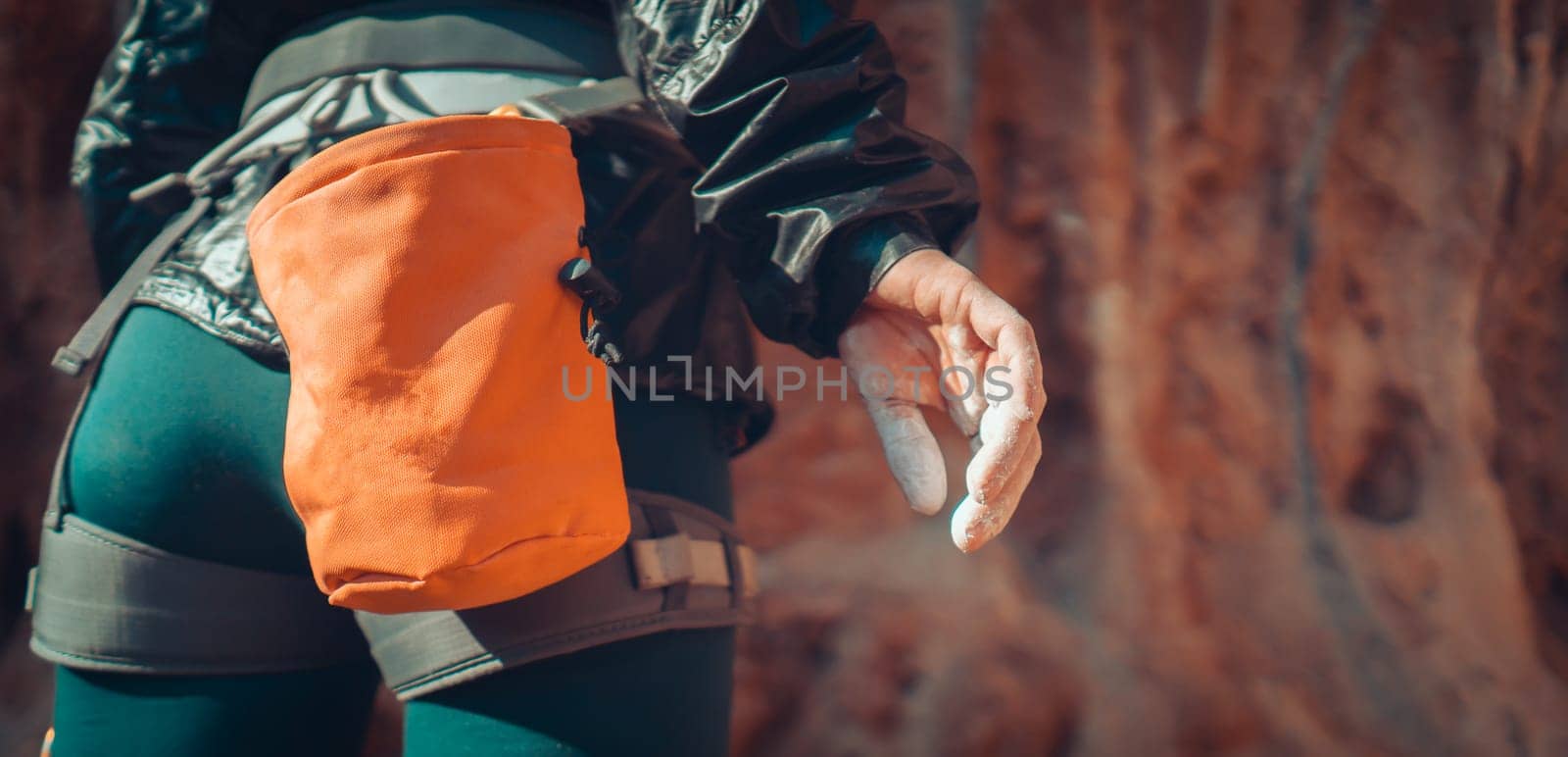 The hand of a young girl with white powder, magnesia close-up, a woman is engaged in active sports, prepares for training, for outdoor climbing.
