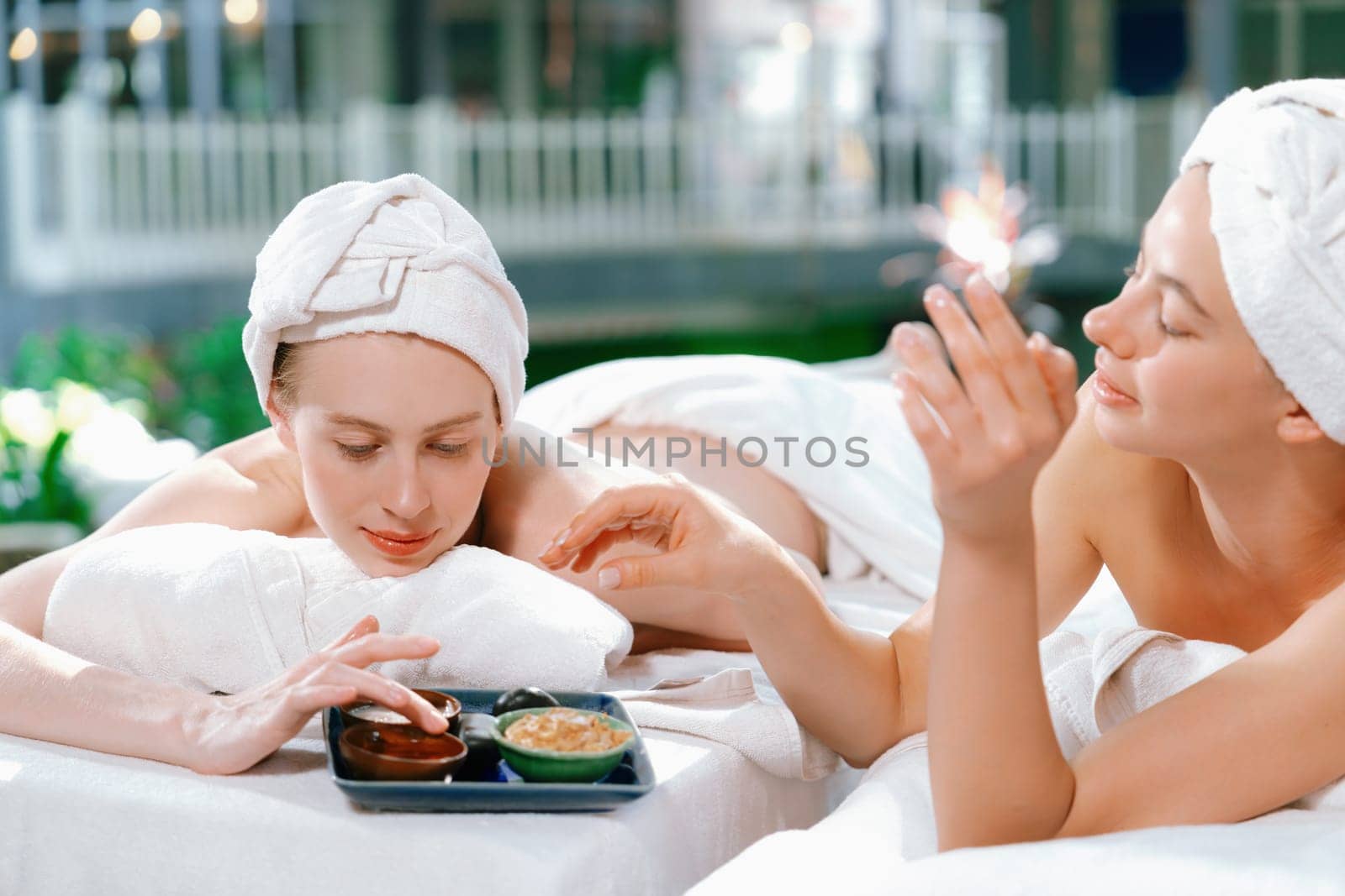 Couple of beautiful young girls interested in homemade facial mask. Tranquility. by biancoblue