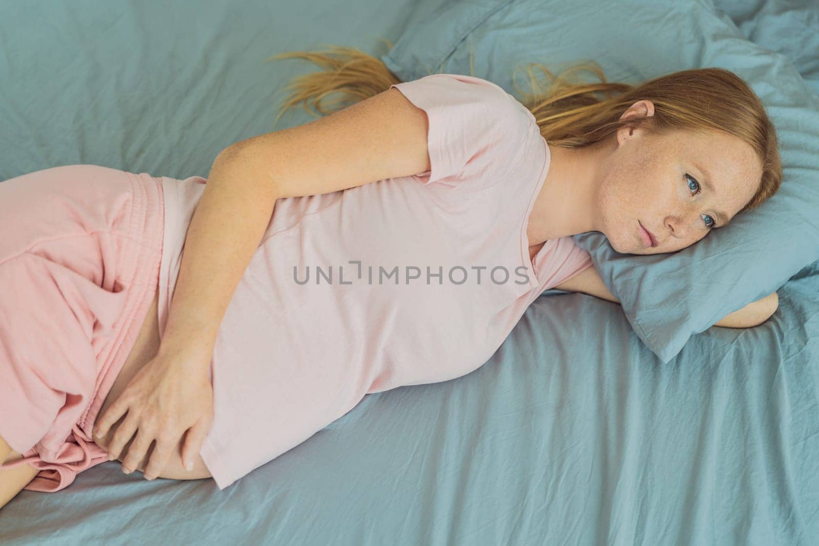 Sleep-deprived pregnant woman struggles with insomnia, navigating the challenges of restlessness during pregnancy by galitskaya