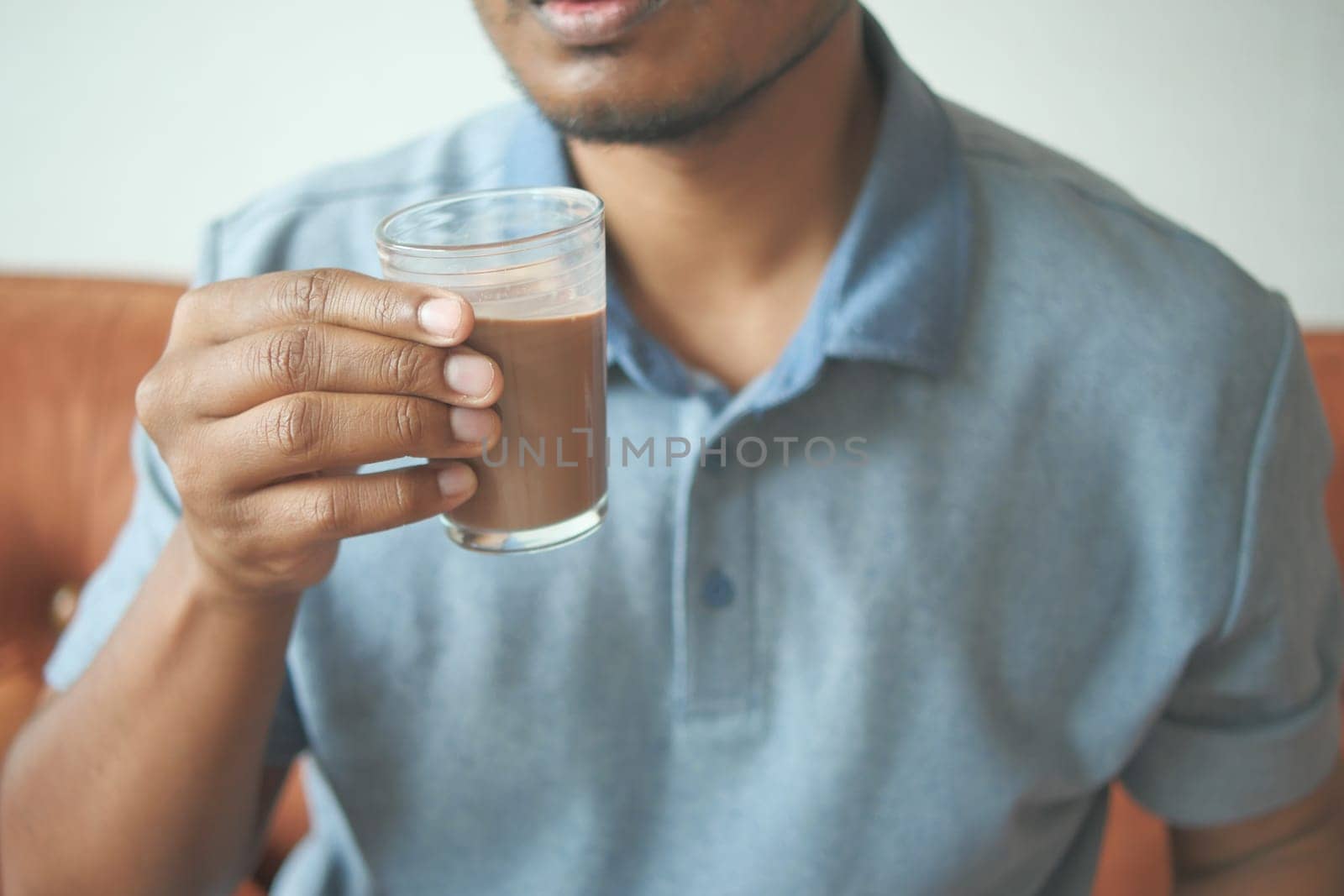 child drinking tasty chocolate milk at home