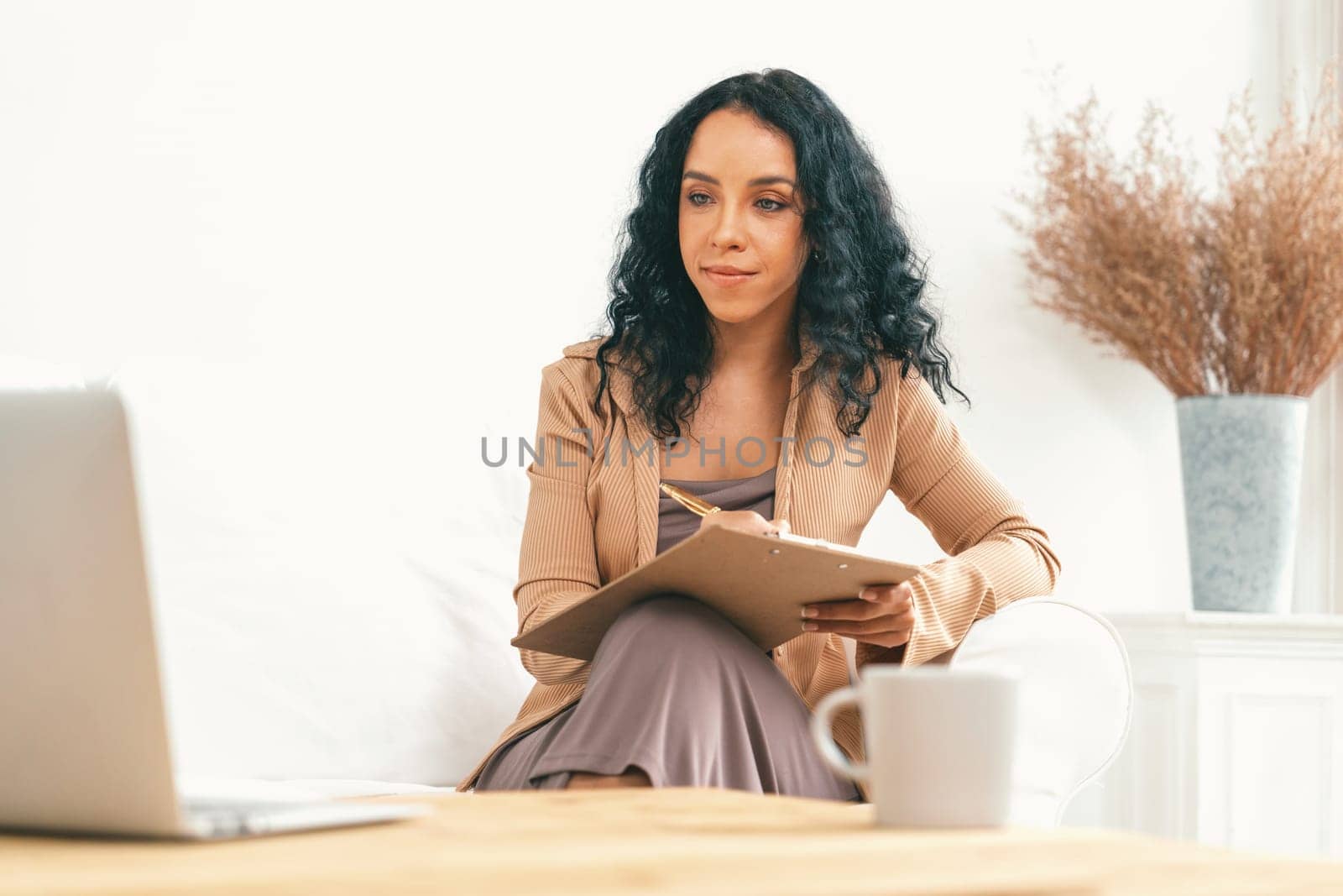 African-American woman using laptop computer for crucial work by biancoblue