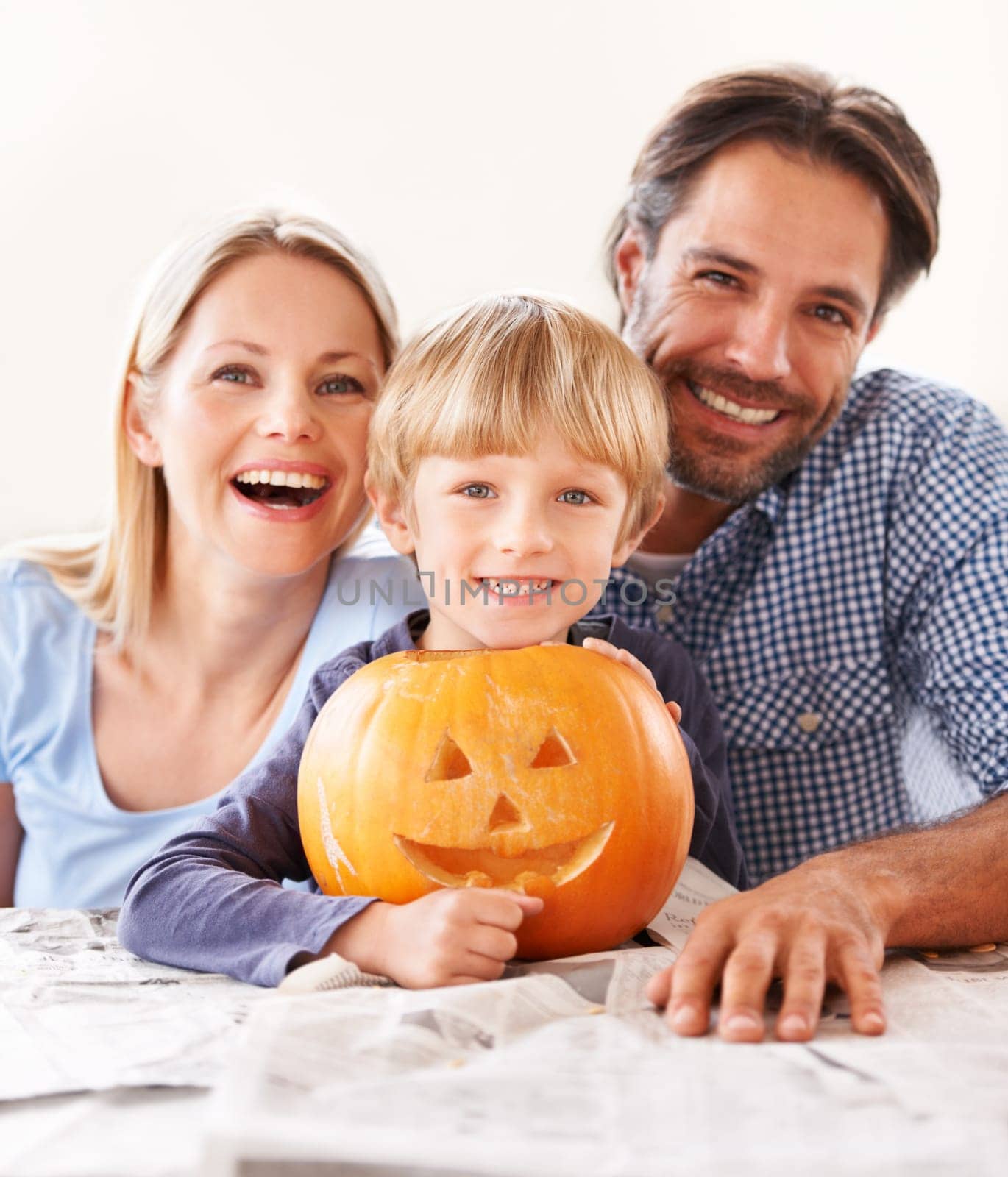 Portrait, parents and kid with pumpkin for halloween to celebrate with fun together. Happy family, mom and dad with boy child carving face in vegetable for holiday lantern, decoration and party.