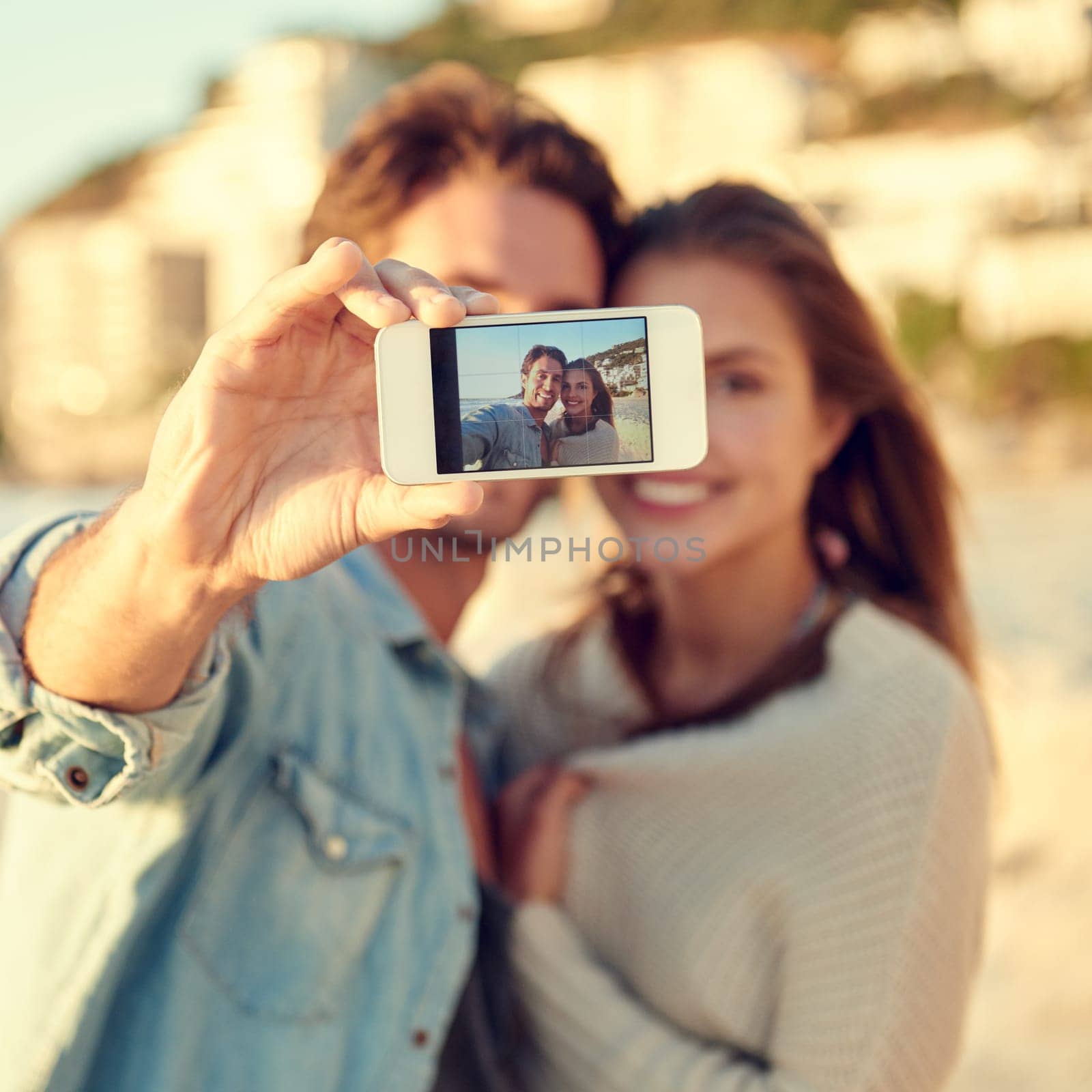 Couple, selfie and smile for hug by ocean for memory on vacation with care, love and tropical beach. Man, woman and smartphone screen for photography, profile picture and app by sea on social media.