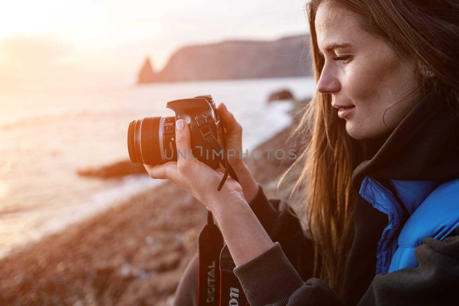 Woman travel sea. Happy tourist enjoy taking picture outdoors for memories. Woman traveler looks at sea bay of mountains, sharing travel adventure journey by panophotograph