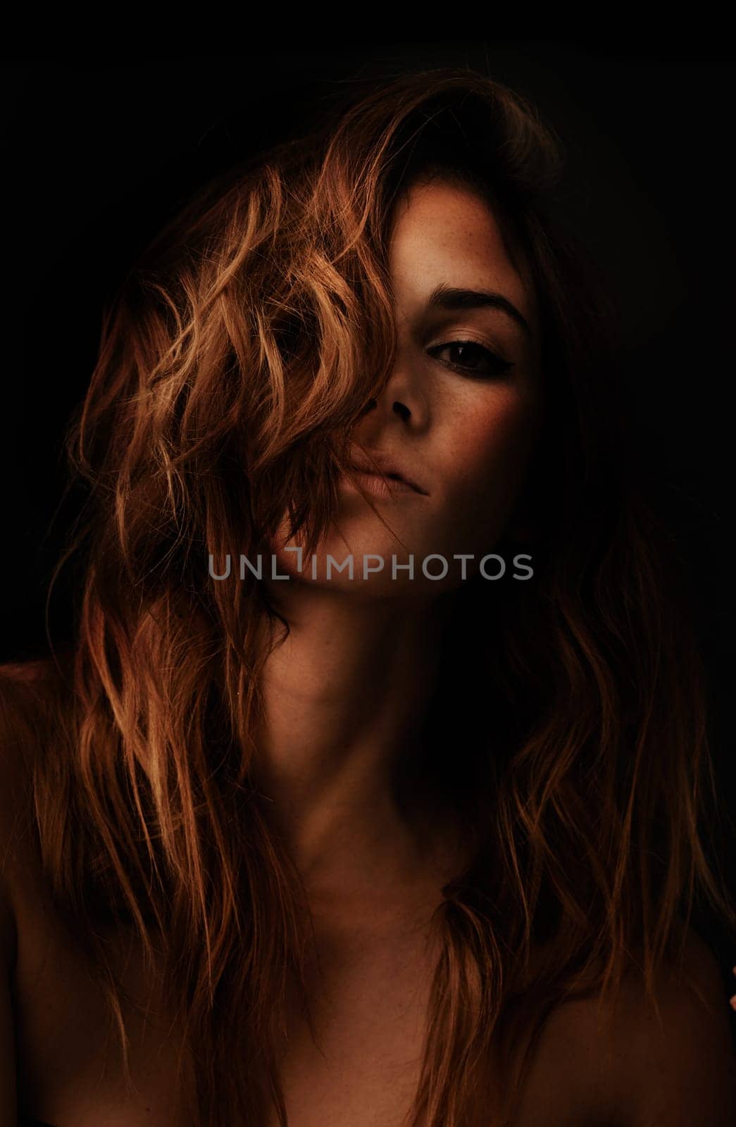 Woman, hair care and ginger portrait with cosmetic and shampoo treatment in studio with shadow. Relax, beauty and person with wavy texture and fresh haircut with salon coloring with black background by YuriArcurs