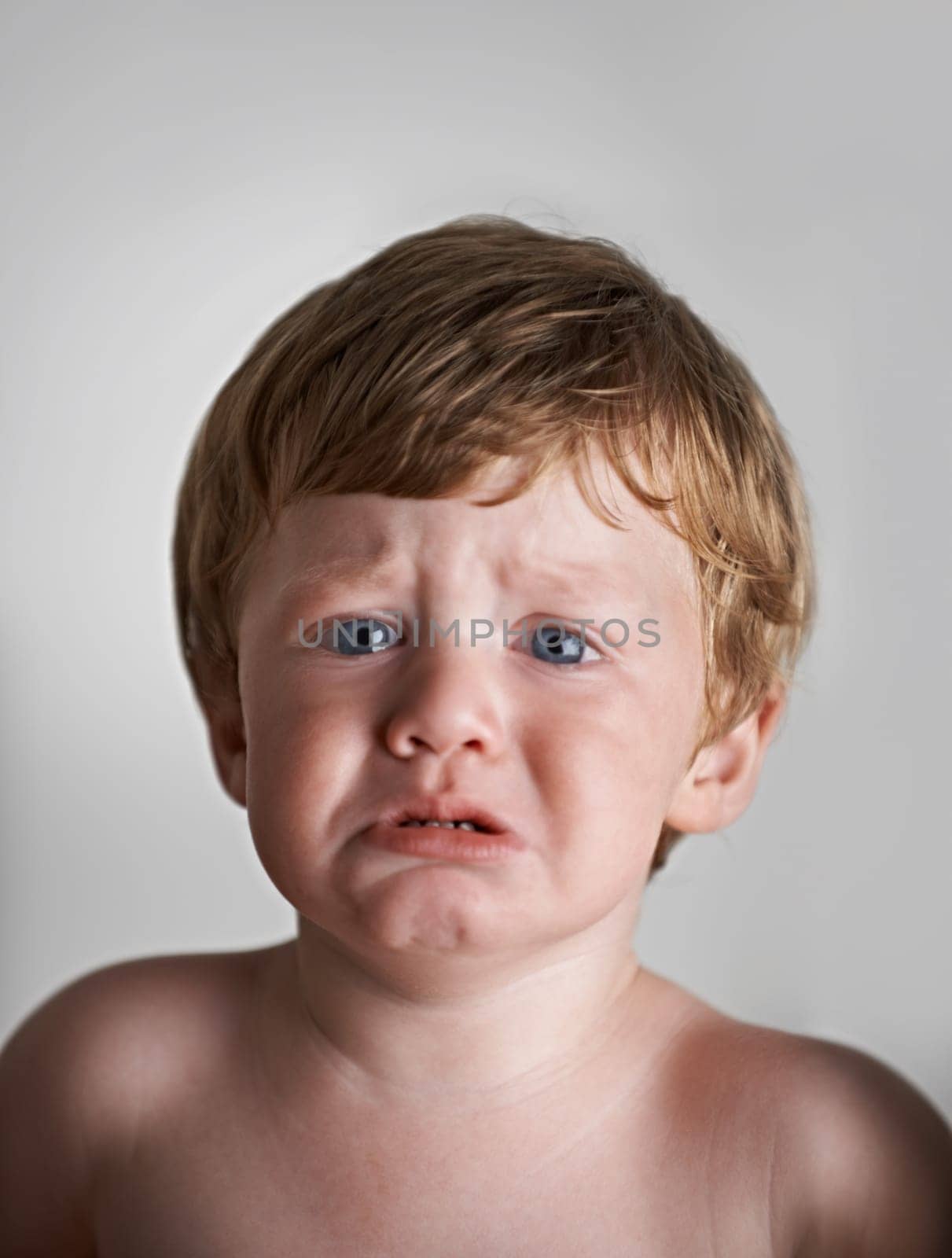 Sad toddler, anxiety and portrait of baby in his home with emotional problem or loss in childhood. Crying, trouble and house with a frustrated young male kid, infant or boy with tears, fear or crisis.