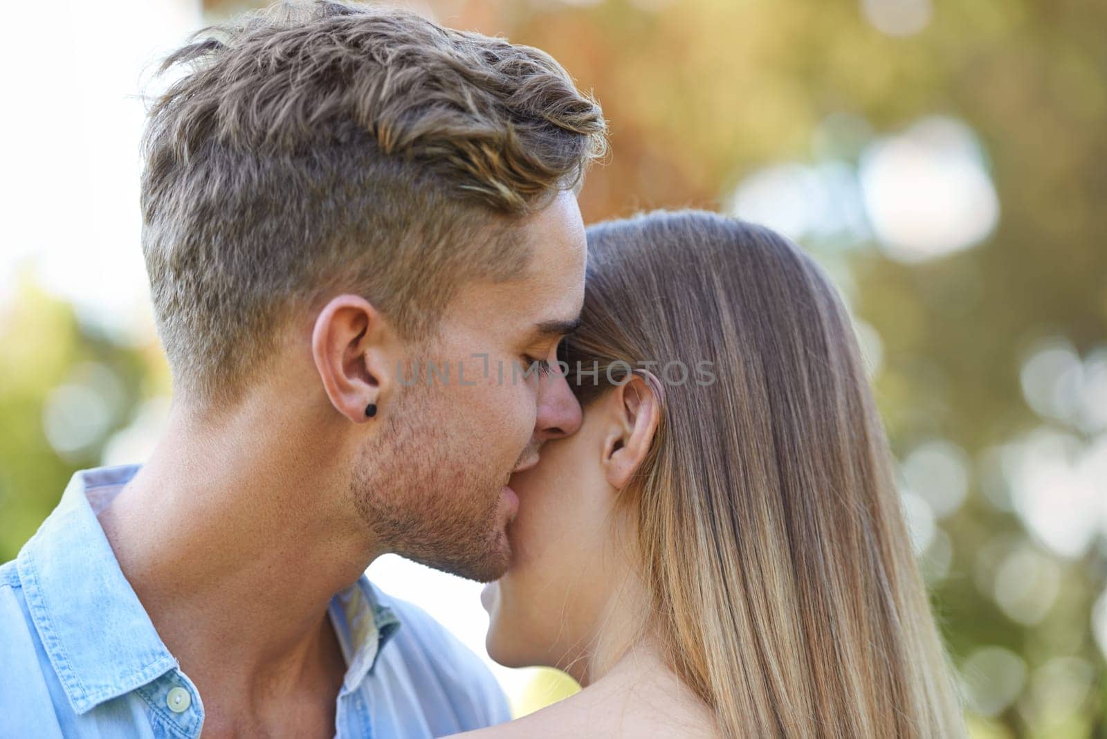 Couple in a park, romance and hug with happiness, summer and marriage with weekend break and bonding together. Outdoor for a date, man and woman with relationship and moment with love and vacation by YuriArcurs