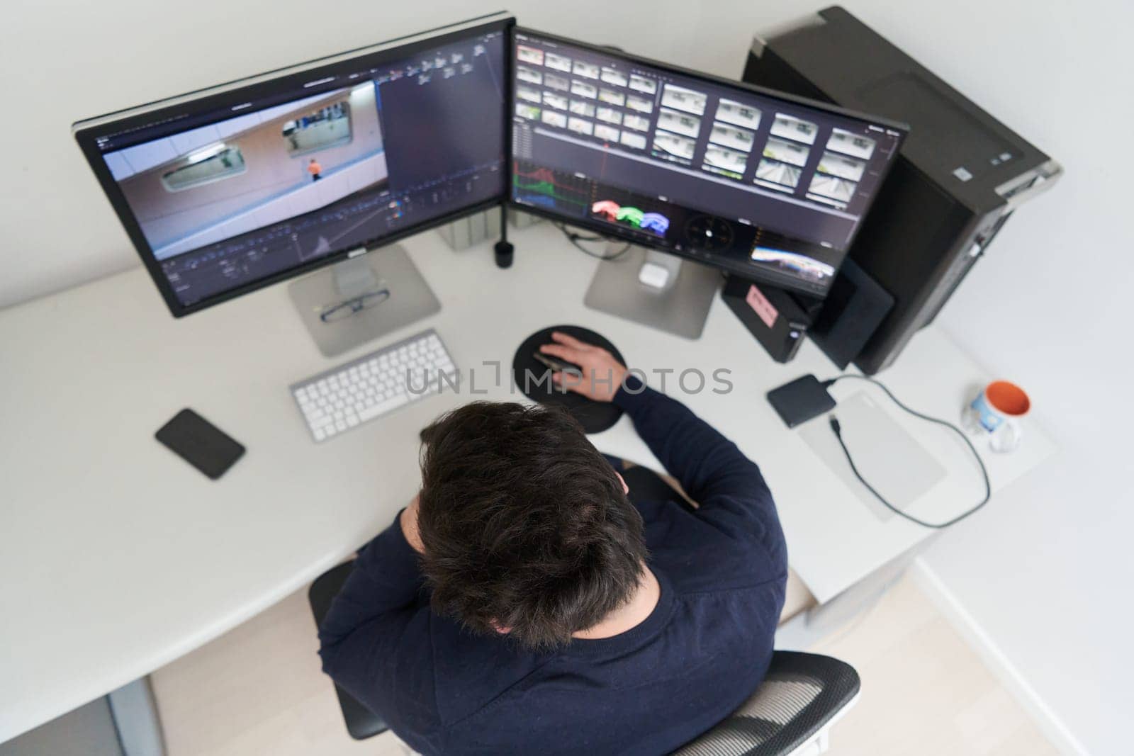 professional video editor enhancing digital footage using specialized software by dotshock