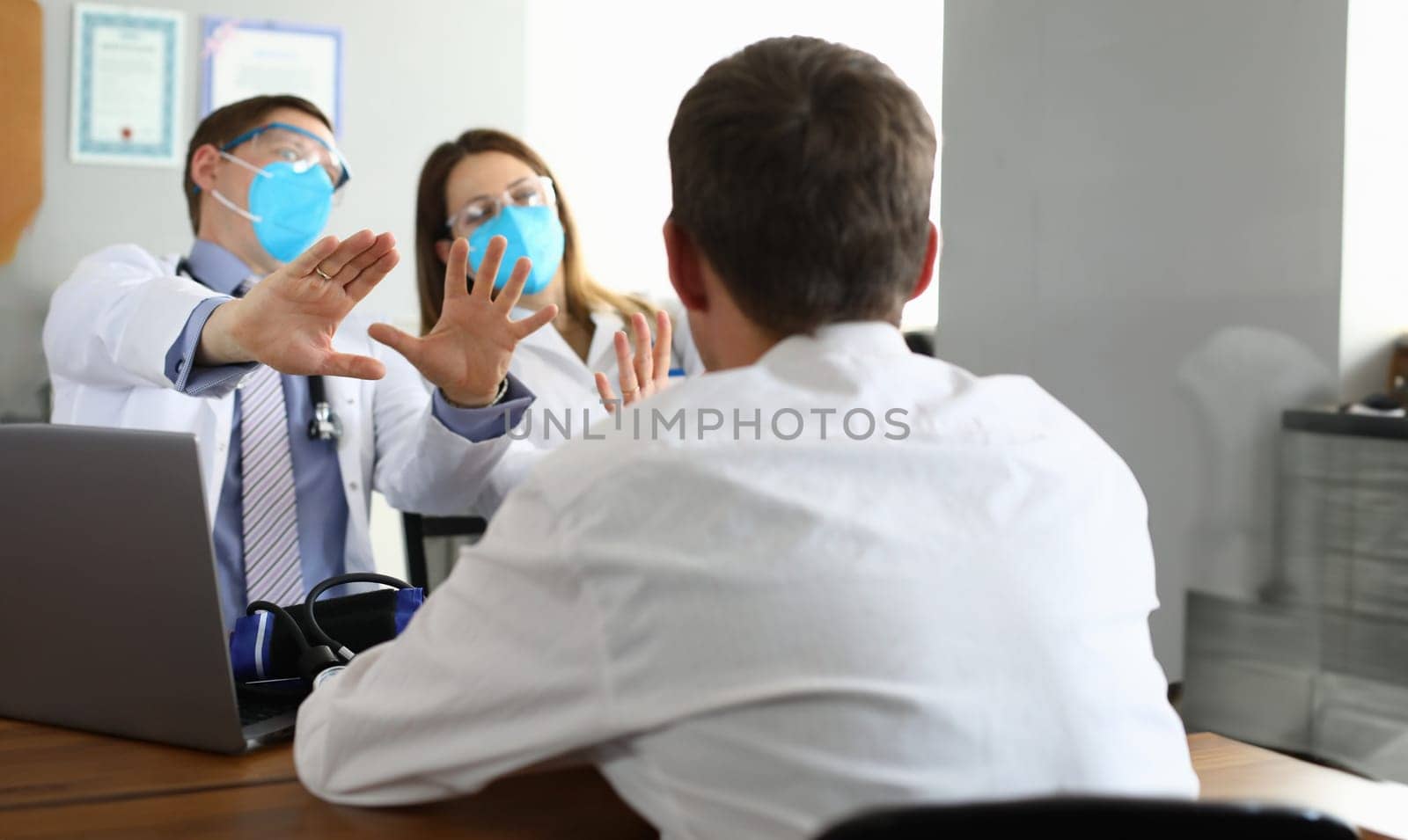 Patients look at scared doctors in respirators by kuprevich