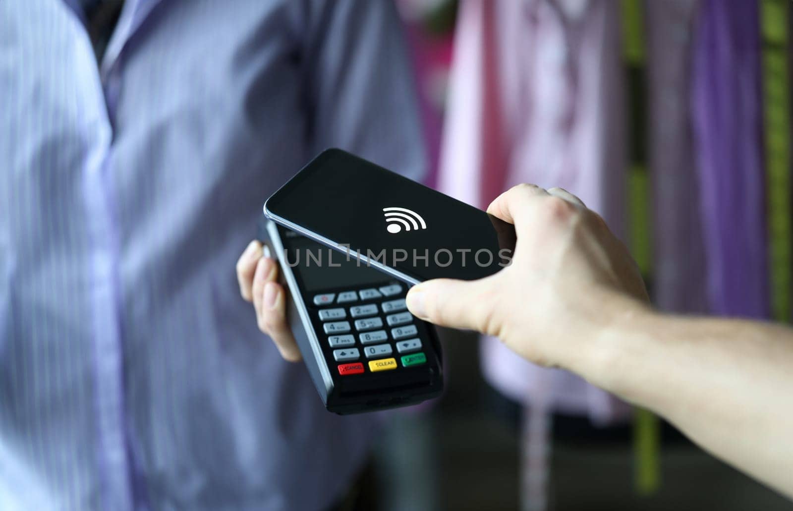 Hand holds out terminal for credit card payment by kuprevich