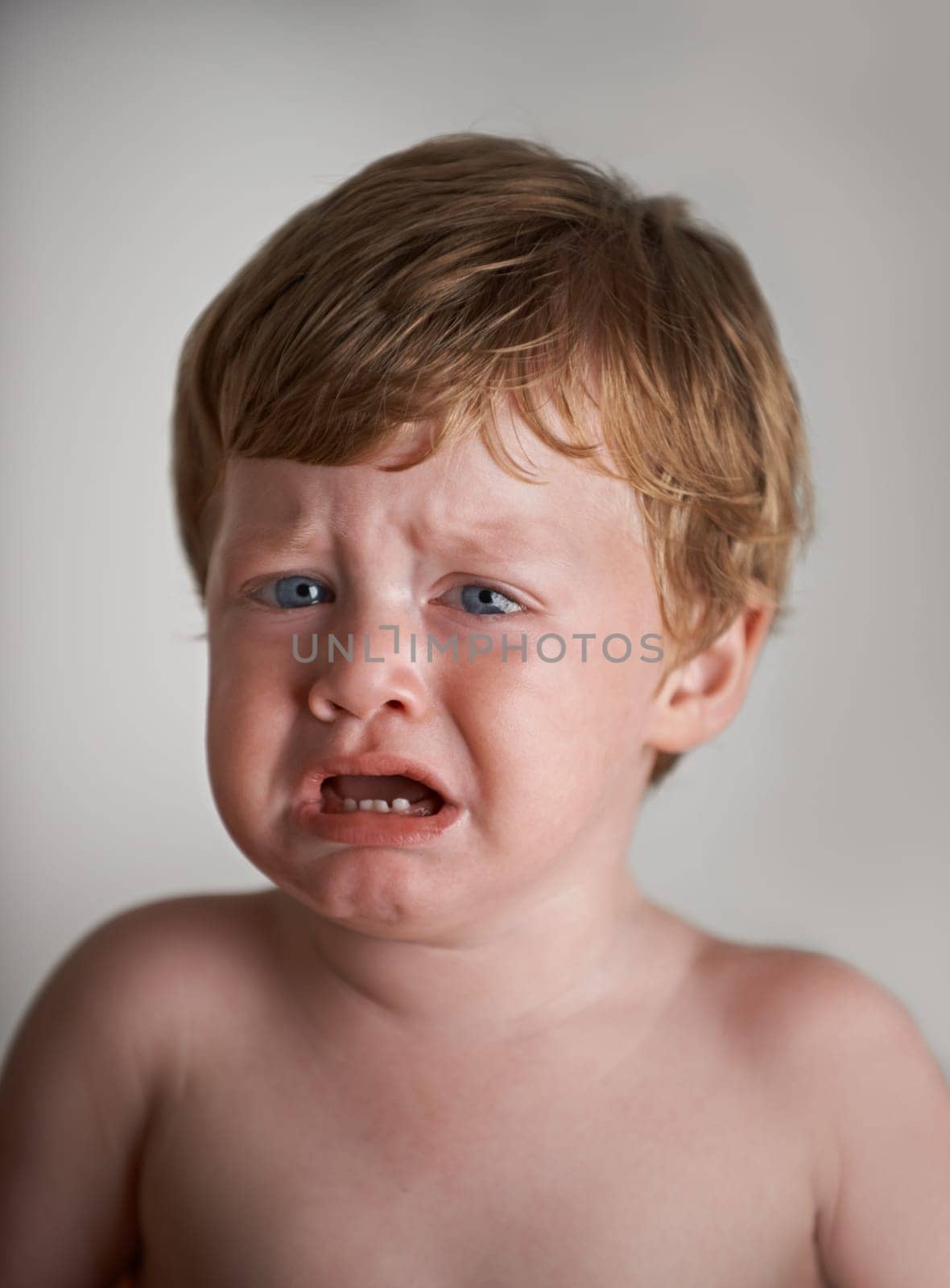 Sad toddler, crying and portrait of boy in his home with emotional anger or loss in childhood. Moody, trouble and house with a frustrated young male kid, infant or baby with tears, fear or noise.