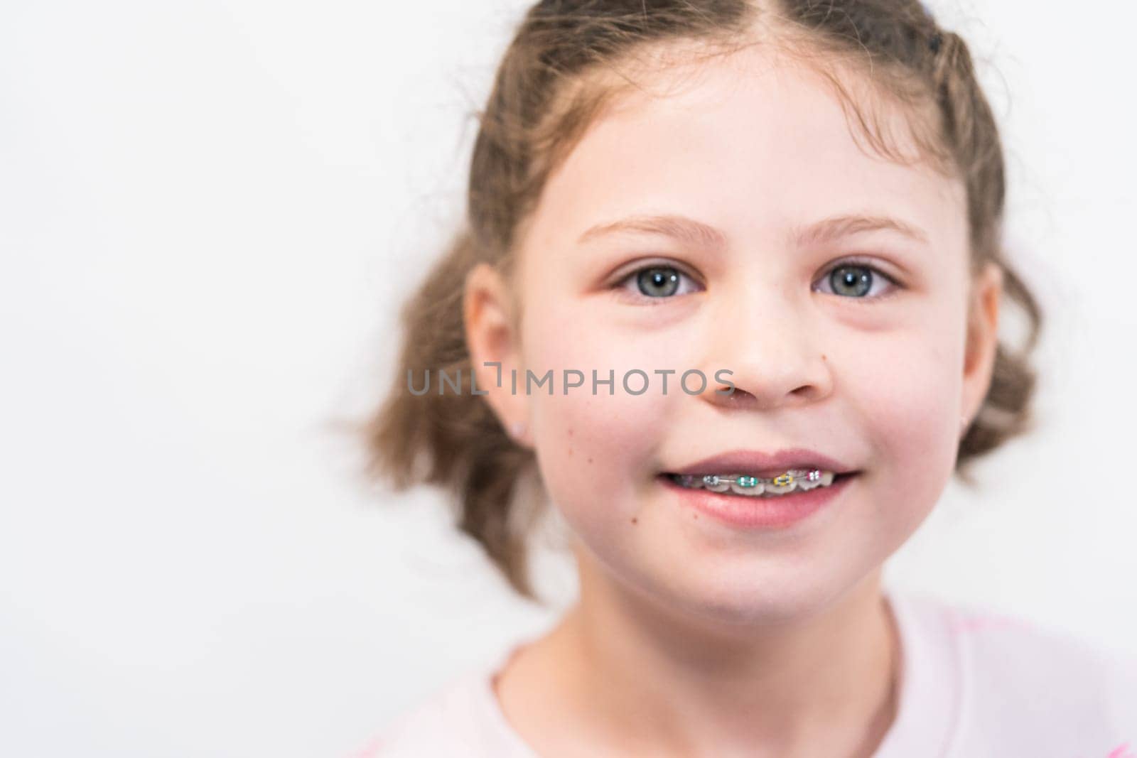 Little girl with rainbow braces by arinahabich