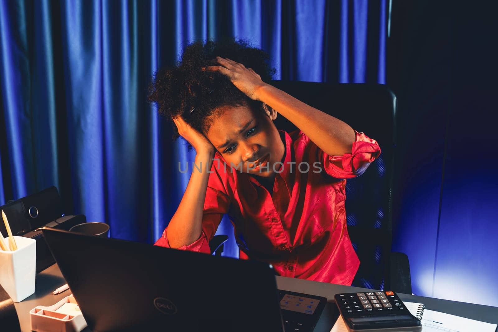 Working African businesswoman suffering from headache with online job, sitting at home office, analyzing marketing plan for target. Concept of stress, tension, over thinking expression. Tastemaker.