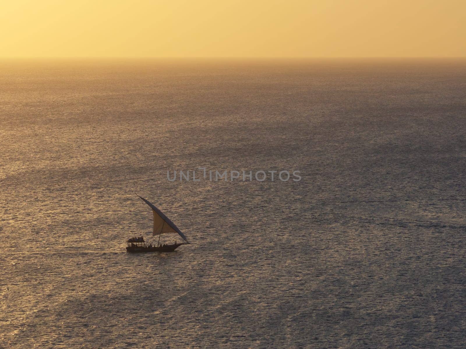 Typical dhow boat sails in the ocean at sunset by Robertobinetti70