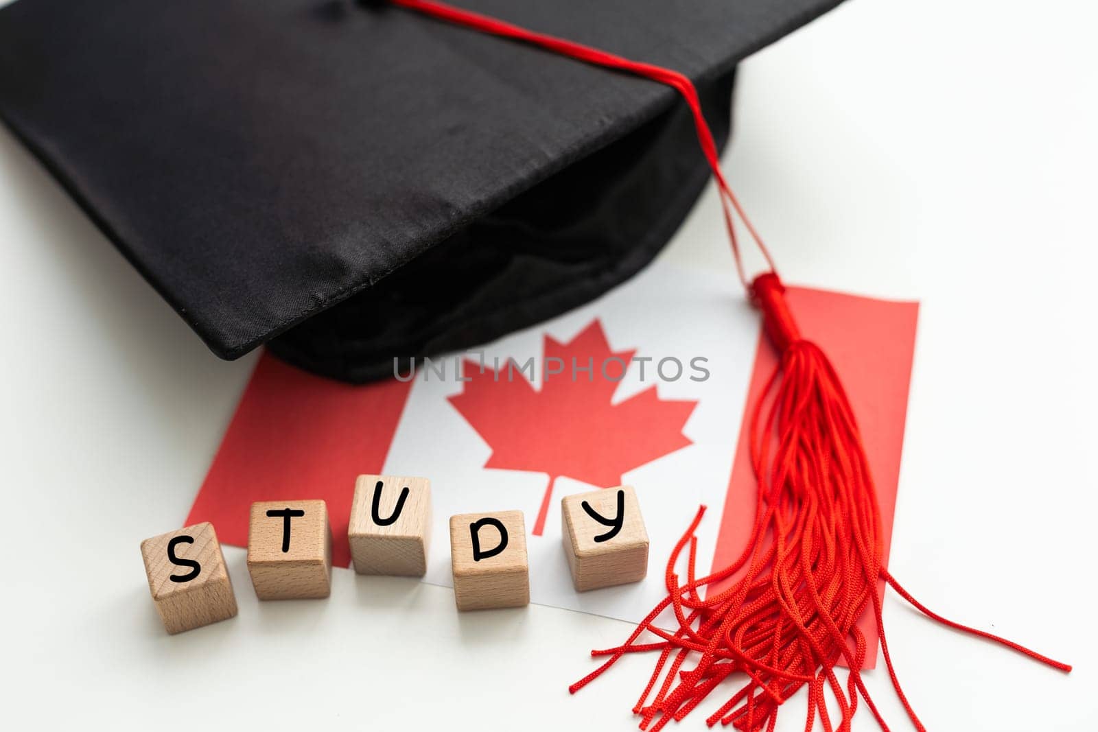 Graduation gap hat and wooden cubes, Education study testing learning teach concept. by Andelov13