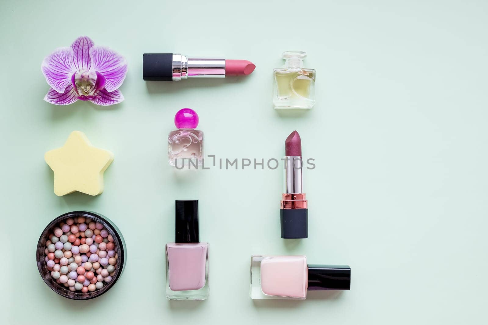 Colorful make up products with golden pursue close up pop art flat lay scene