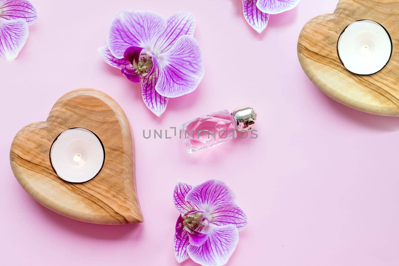 Beautiful spa composition.wellness and spa composition with perfum, burning candles and orchid flowers on pink background. top view. copy space.Time to relax, spa ritual. by YuliaYaspe1979