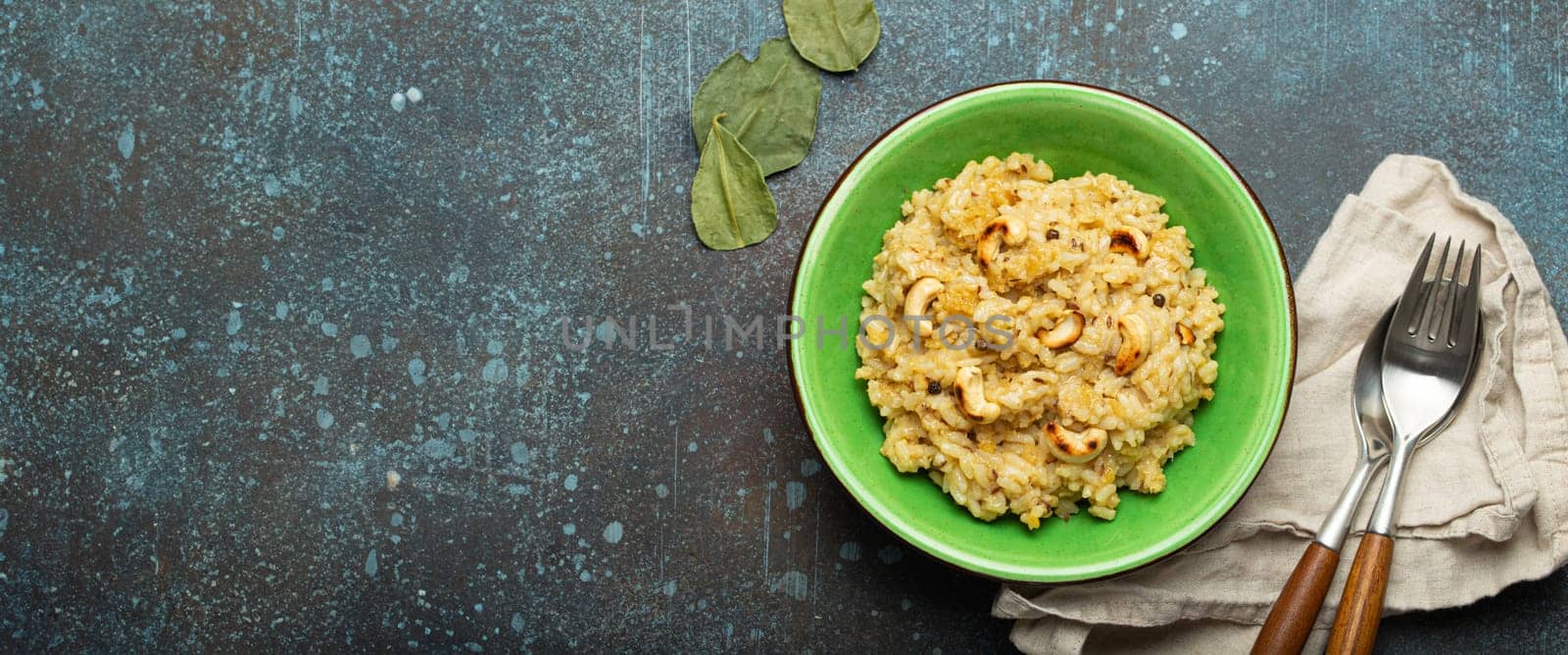 Ven Pongal (Khara Pongal), traditional Indian savoury rice dish made during celebrating Pongal festival, served in bowl top view on concrete rustic background, space for text.