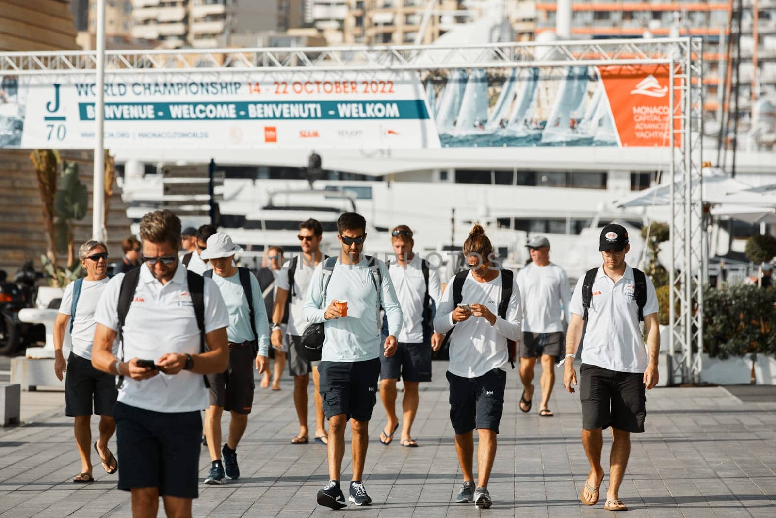 Monaco, Monte-Carlo, 18 October 2022: a group of yachtsmen participating in the upcoming sailing race goes to the yacht club, teams from different countries, the World Championship of J70 class by vladimirdrozdin