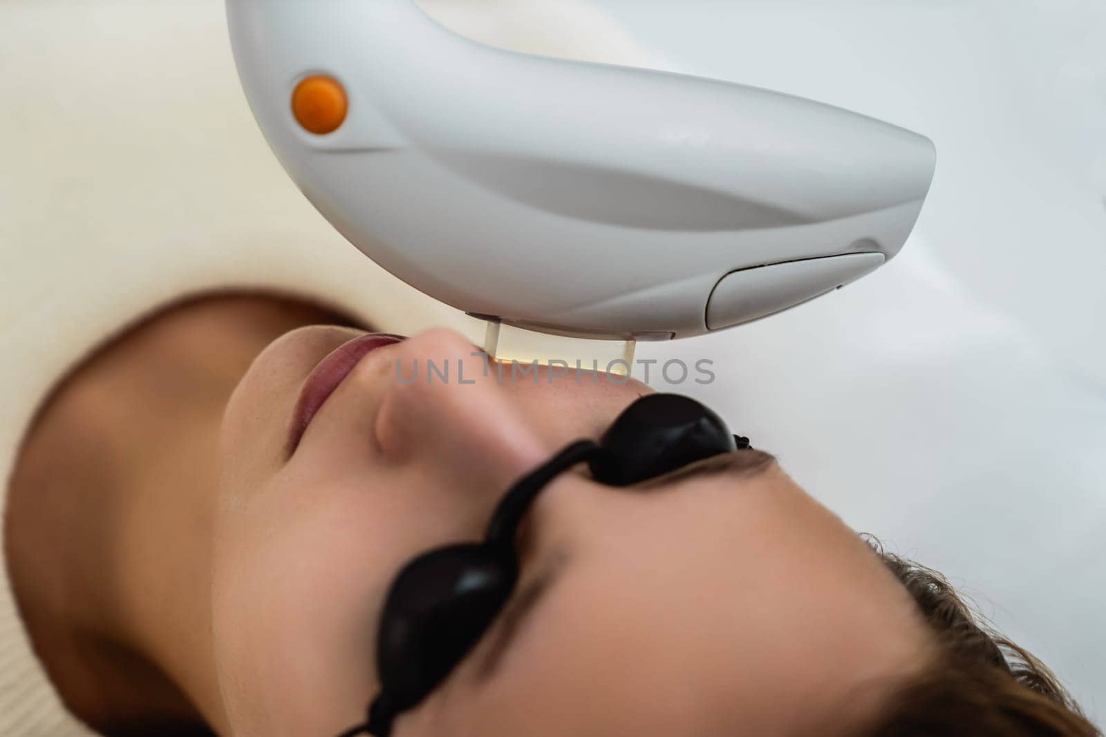 Phototherapy, photorejuvenation, IPL in a beauty salon. Care for a woman's face. High quality photo