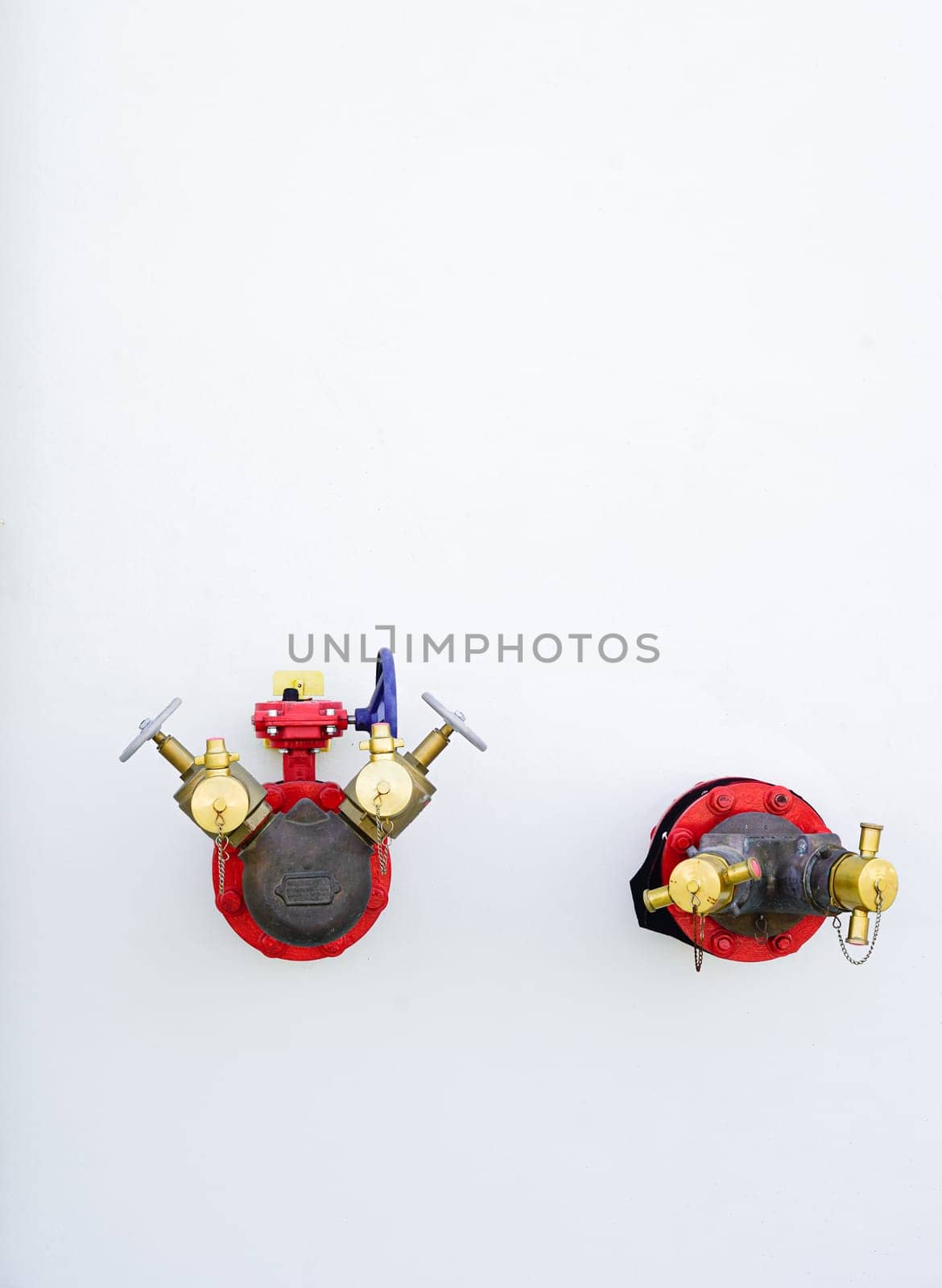 Red fire hydrant system, fire extinguishing system on white wall