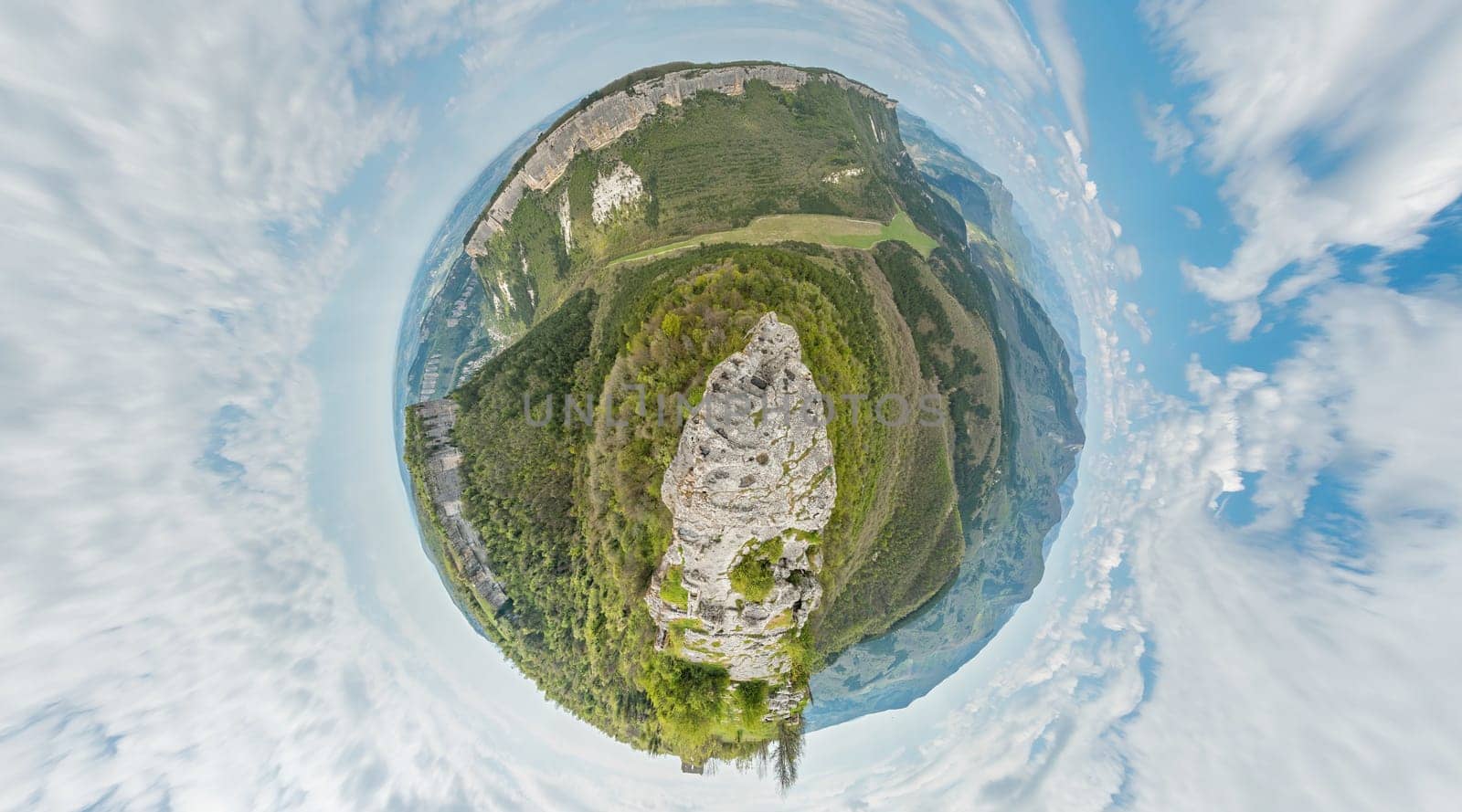 Wide panoramic view on mountain landscape with lush green hills under clear blue sky, tranquil natural beauty, perfect for outdoor enthusiasts. Little planet 360 panorama by panophotograph