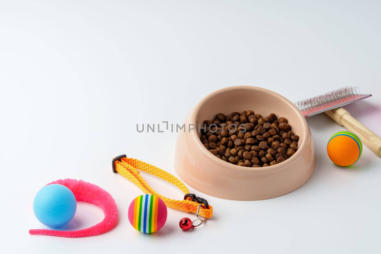 Bowl with dry pet food isolated on white background close up