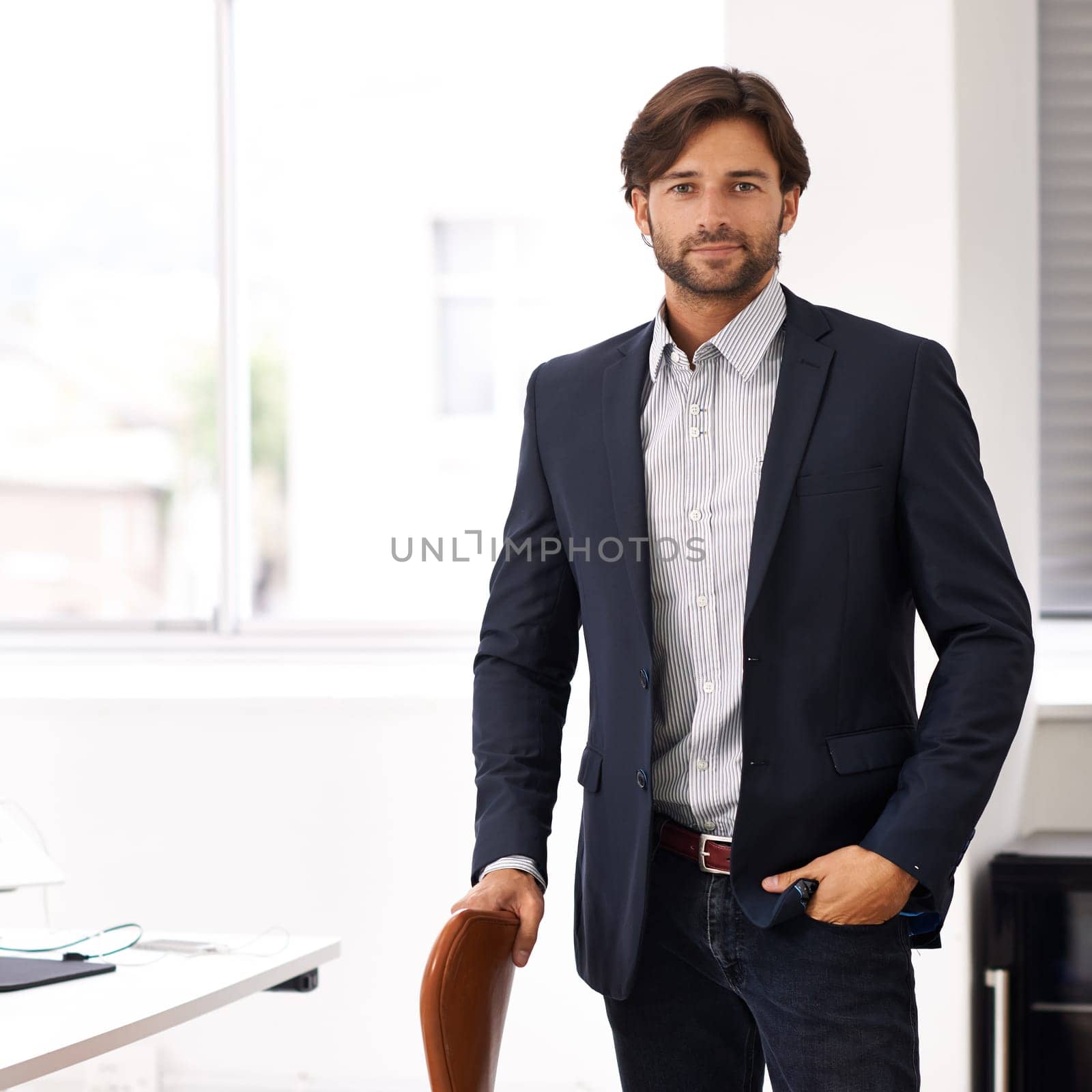 Portrait, office and businessman at startup with confidence, casual fashion and small business. Creative professional, art director and entrepreneur at desk with pride, project management and smile