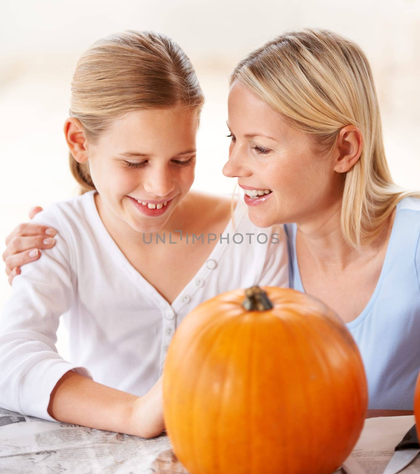 Happy, mother and child with pumpkin to celebrate halloween, party and fun together at home. Young girl, mom and family carving orange vegetable for holiday lantern, decoration or creativity of craft by YuriArcurs
