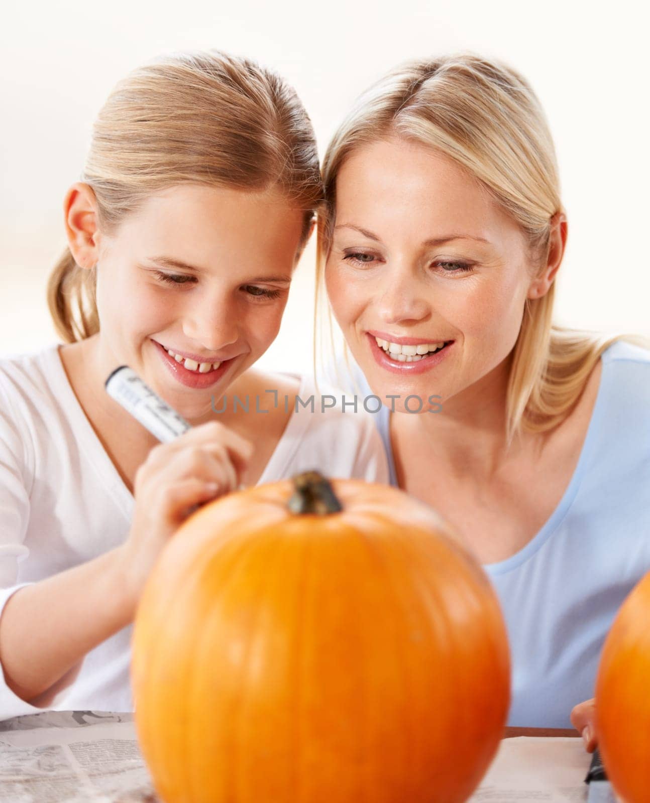 Child, mother and smile for drawing on pumpkin, craft and celebrate halloween party at home. Happy girl kid, mom or family writing with pen marker on vegetable, holiday lantern or creative decoration.