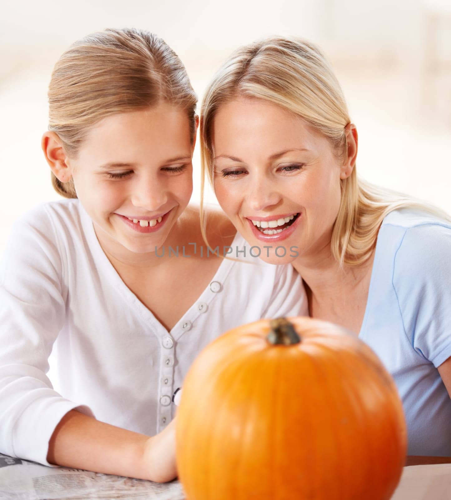 Child, mother and smile with pumpkin to celebrate halloween party together at home. Happy young girl, mom and family carving orange vegetable for holiday lantern, decoration and fun creative craft by YuriArcurs