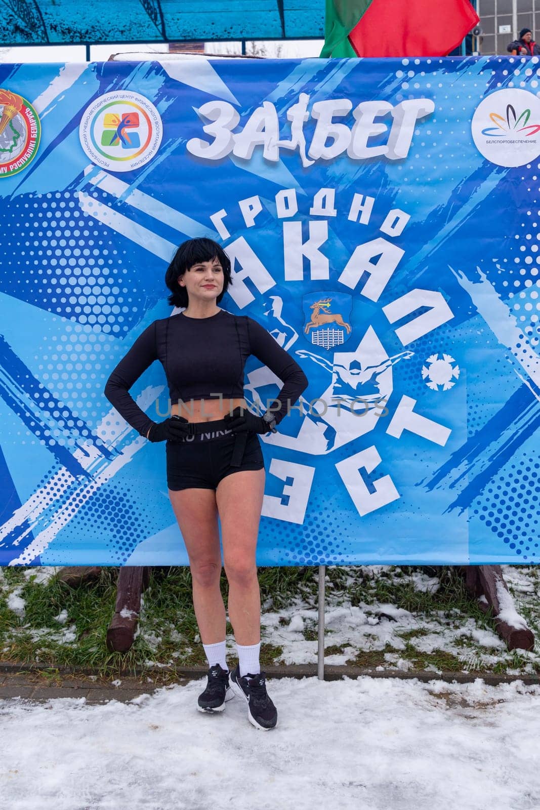 Grodno, Belarus - January 28, 2024: A woman in a swimsuit poses after finishing during the traditional annual Temper-fest race