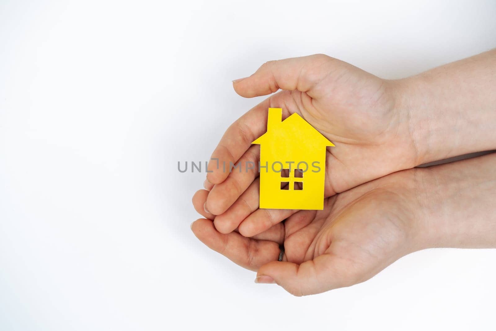 hands holding paper house, family home, homeless housing, mortgage crisis and home protecting insurance concept, foster home care, family day care, social distancing. by Matiunina