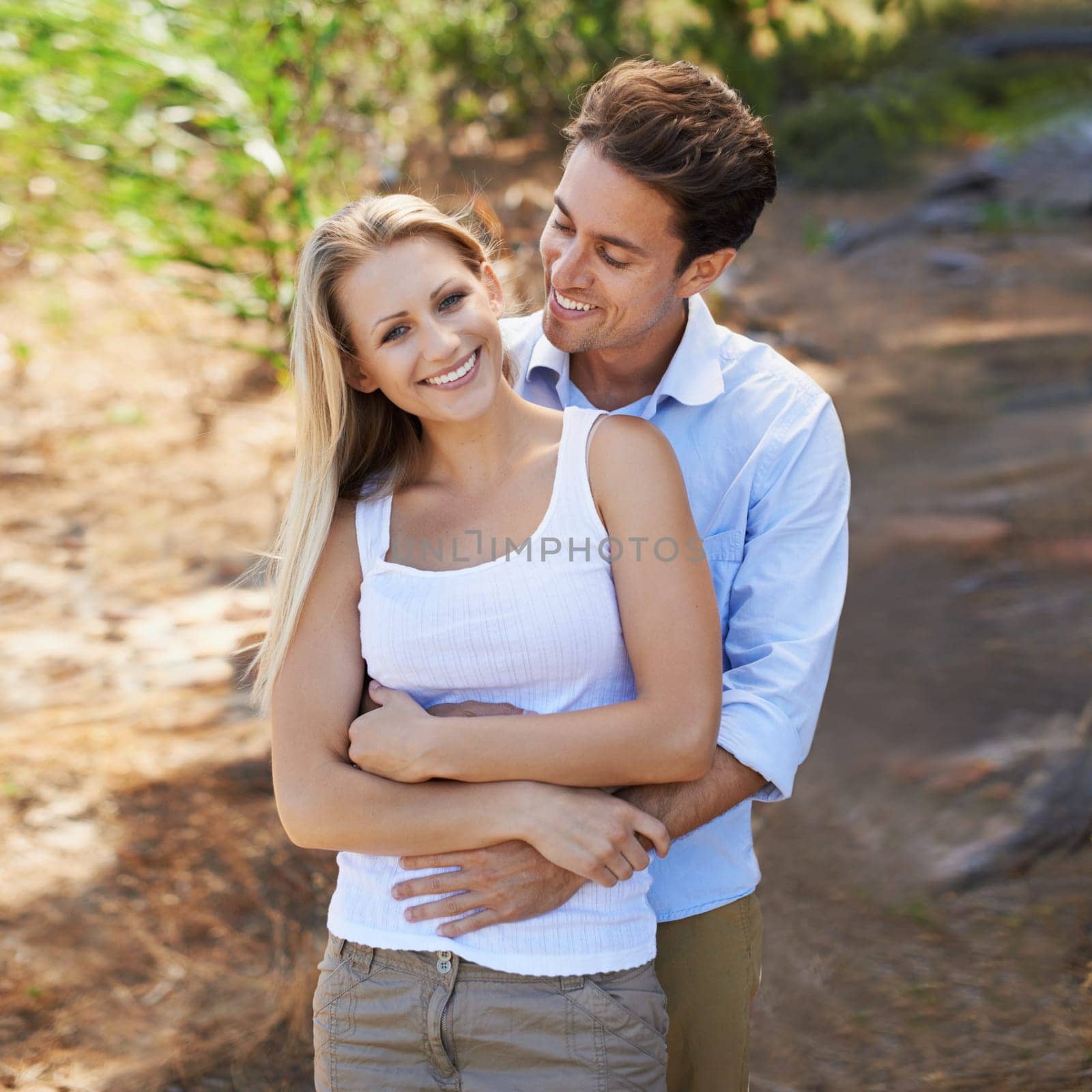 Nature portrait, love and happy couple hug for support, romantic care and relationship security with marriage partner. Embrace, wellness and relax outdoor man, woman or people smile for forest date.