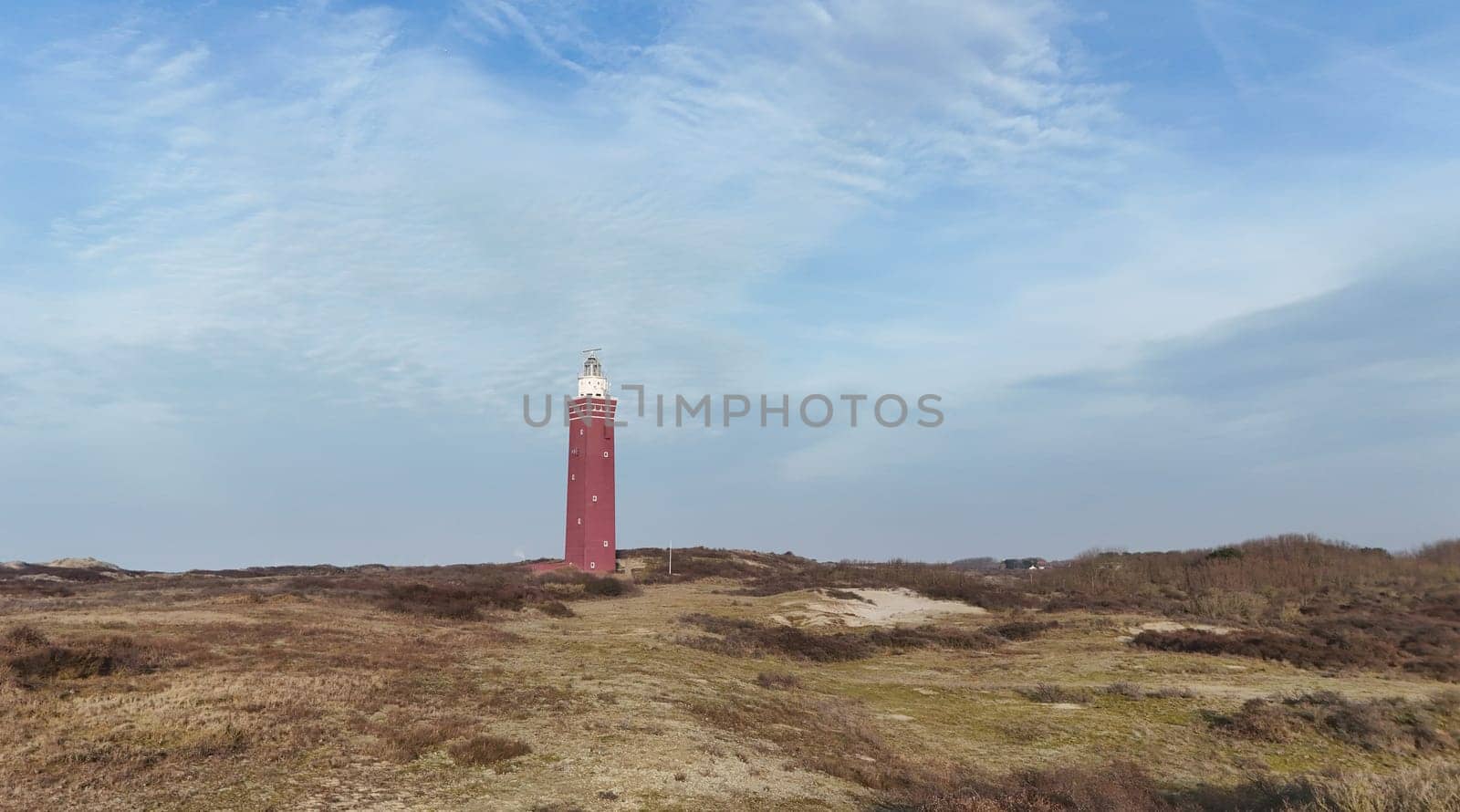 Drone picture of Ouddorp lighthouse in Holland with surrounding dunes in the netherlands