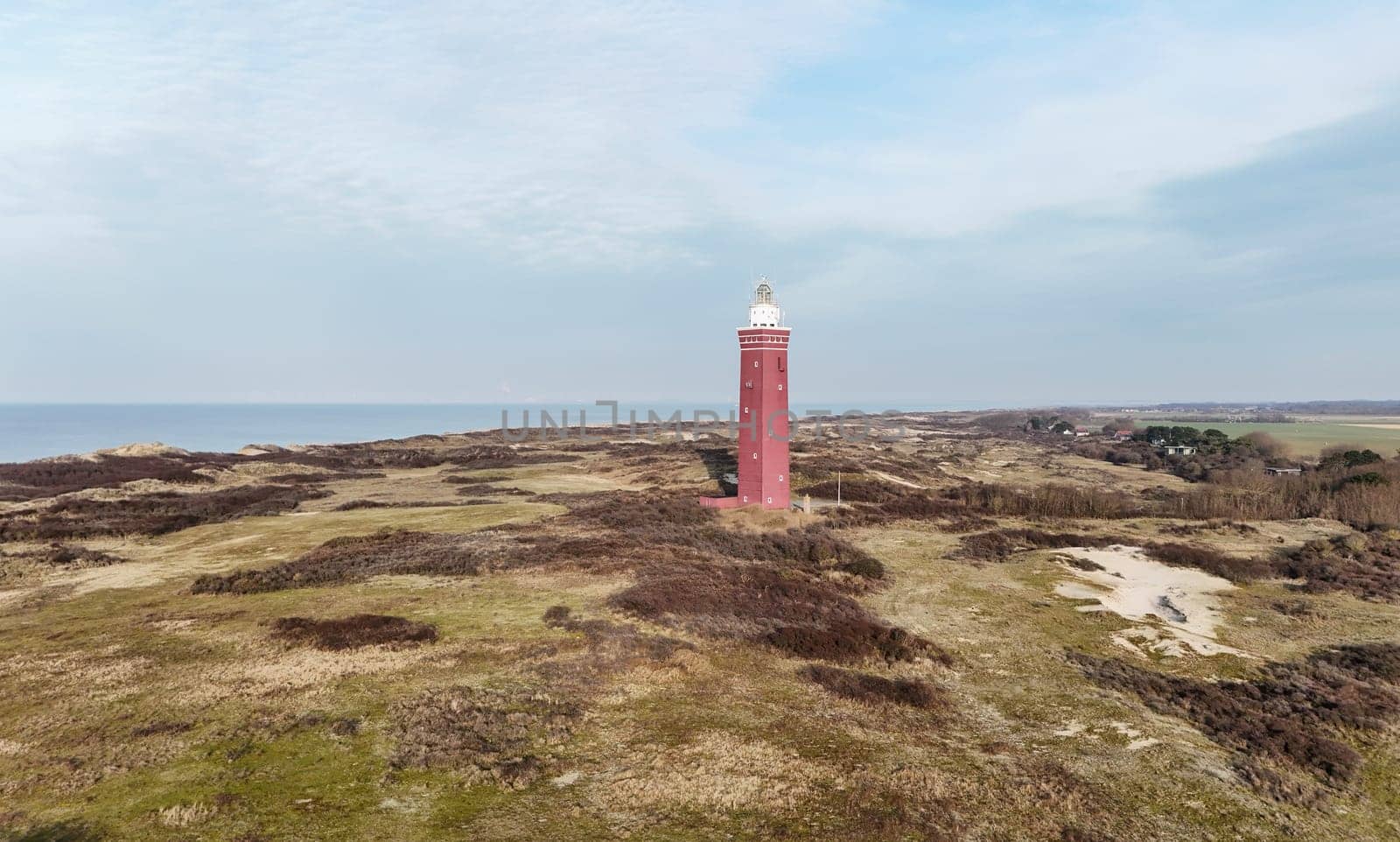 Drone picture of Ouddorp lighthouse in Holland with surrounding dunes in the netherlands