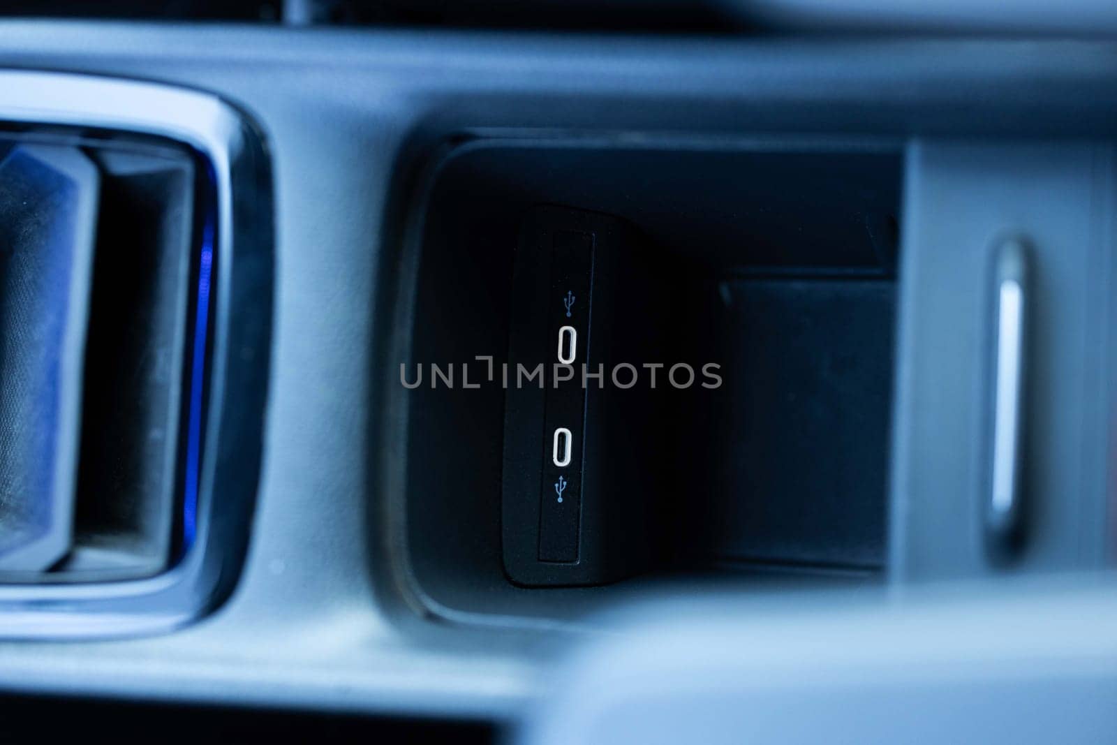 Panel in interior of a new electric car. Two USB C ports in a passenger car. Modern electric car usb socket for charging and accessories. Car interior. by uflypro