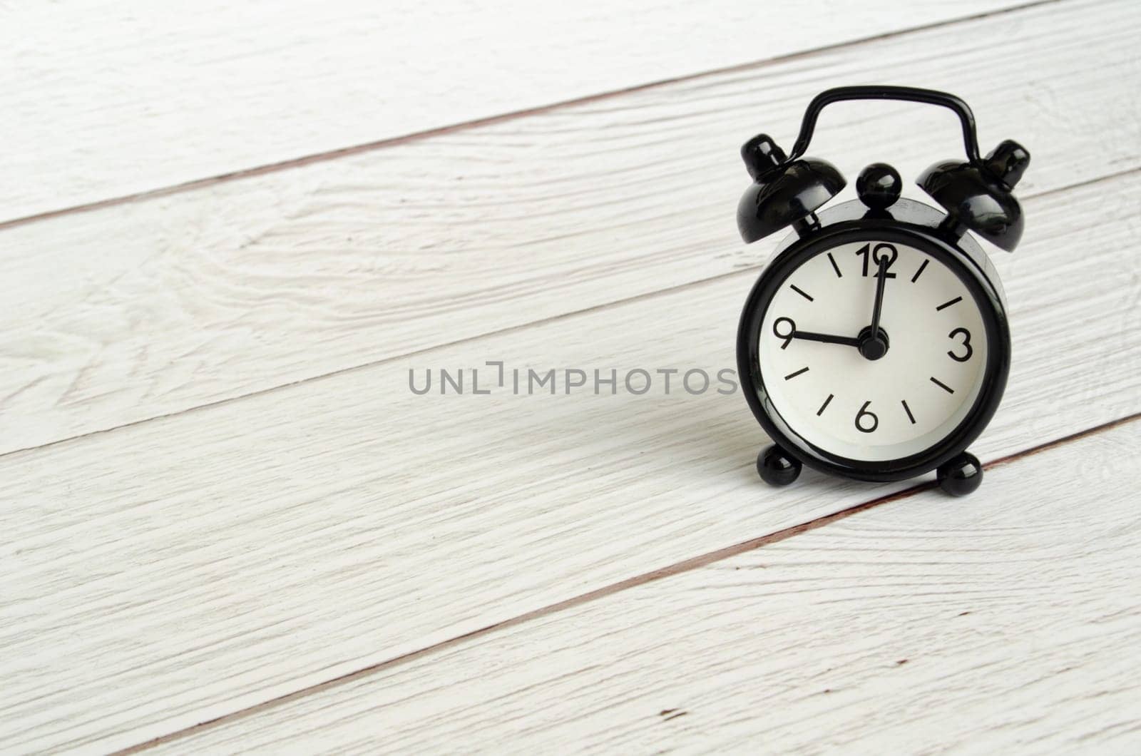 Black table alarm clock with customizable space for text. Time concept and copy space.