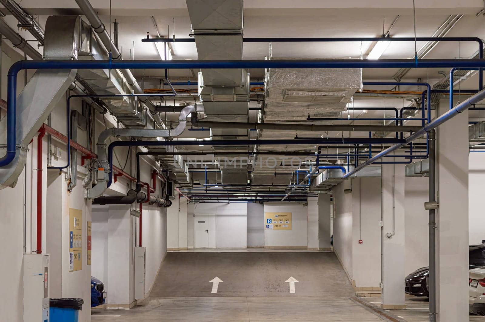 underground parking with utilities and cars from the inside. photo