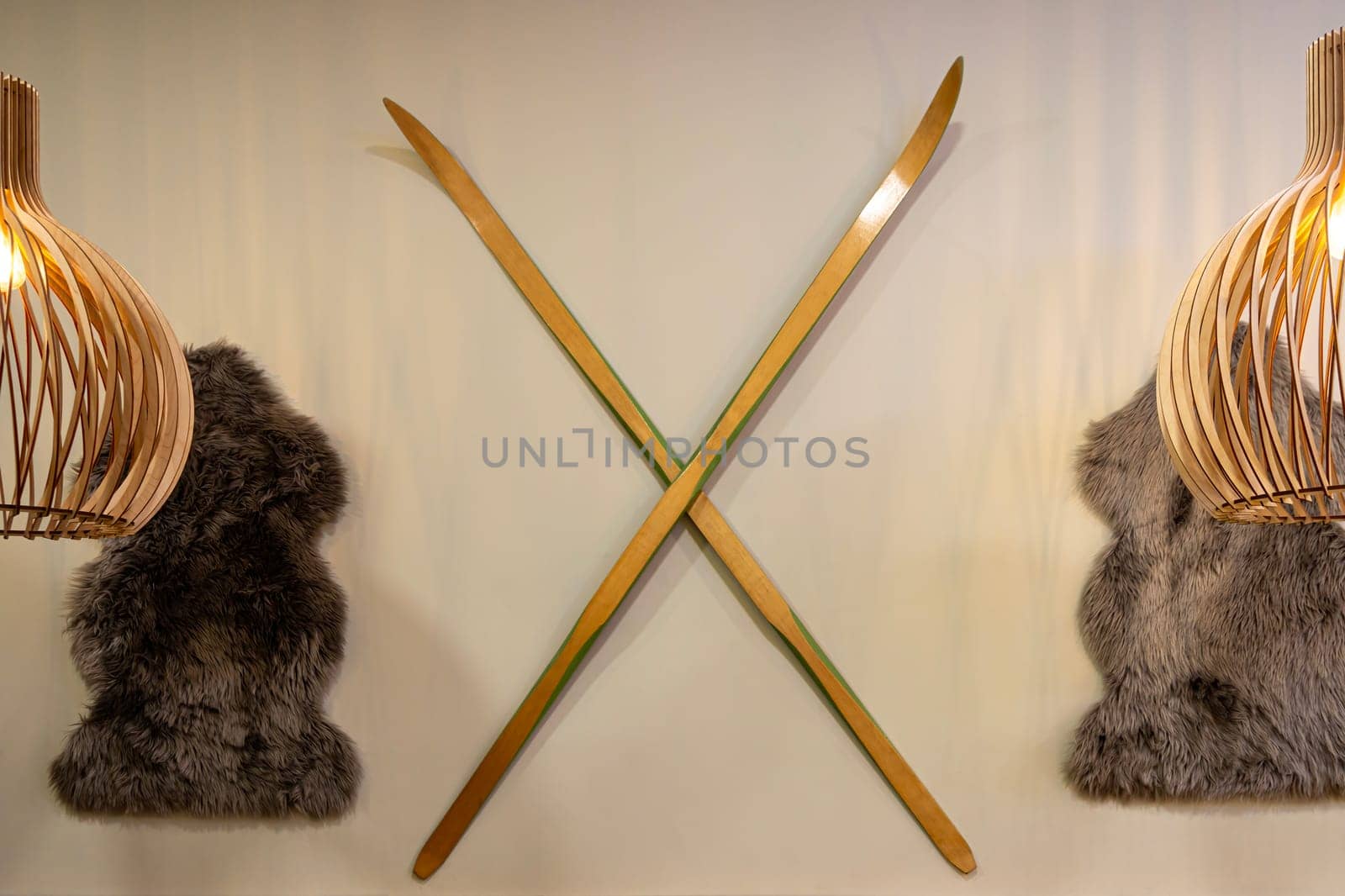 skis and animal skins on the wall by roman112007