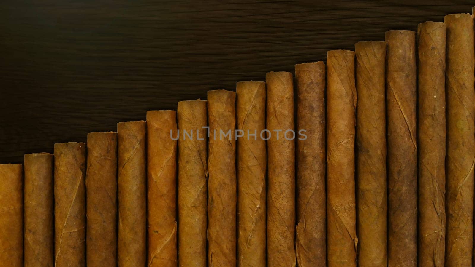 Small cigars lined up. Natural leaf tobacco