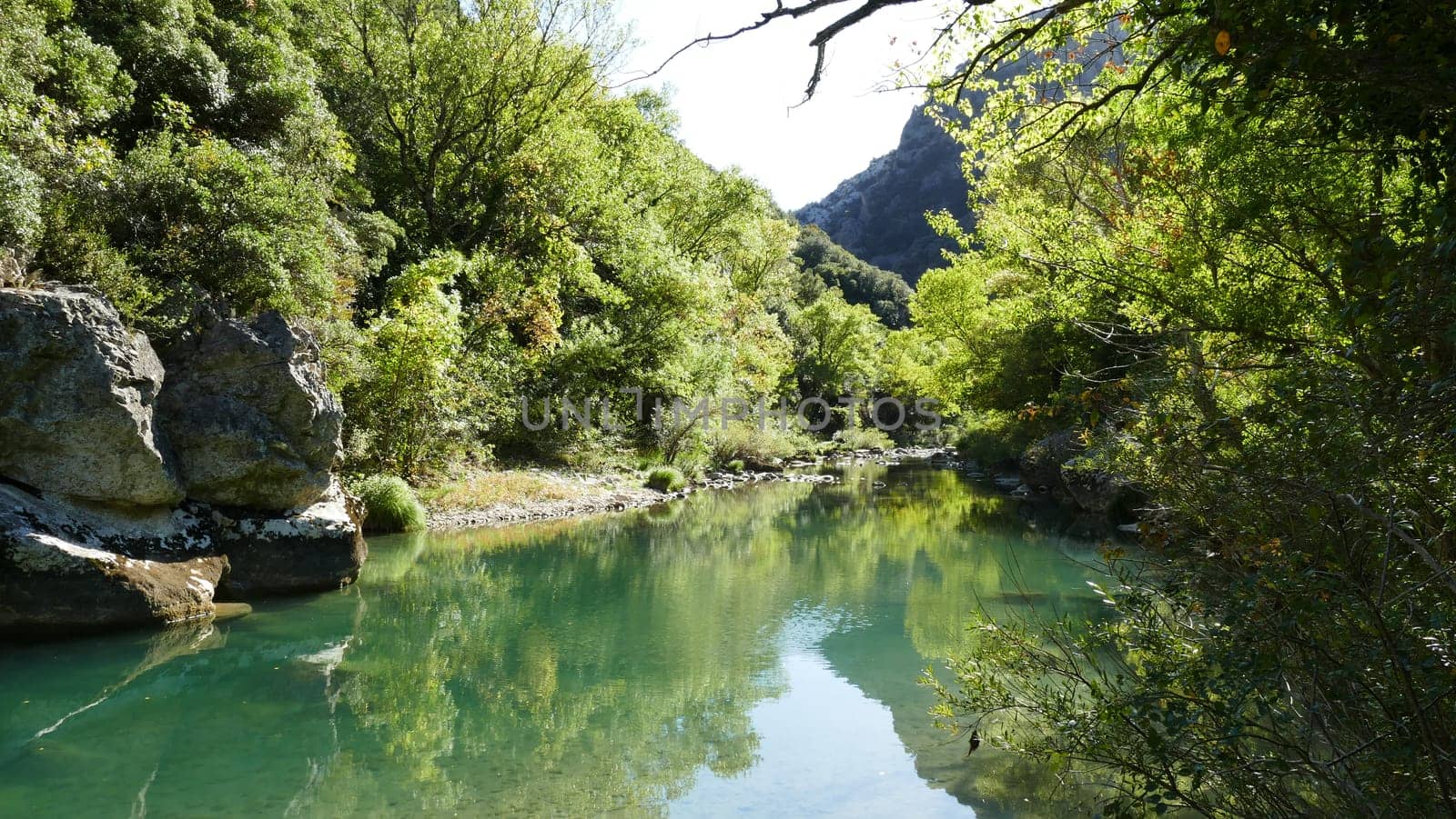 River with stones and vegetation between Yesa mountains in Navarre