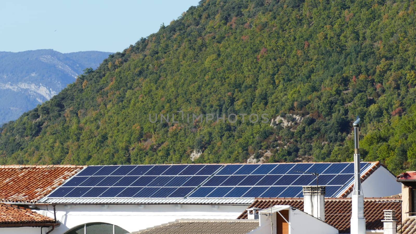 Building with solar panels on the roof of a village of Yesa in Navarre by XabiDonostia