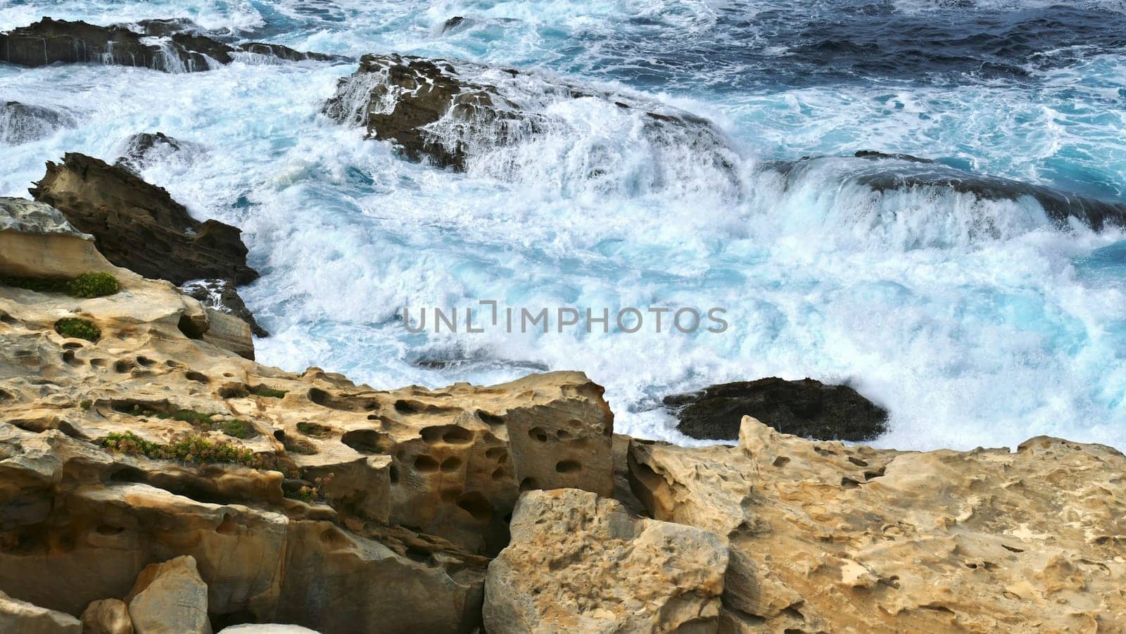 Coast of the sea with waves crashing on the rocks