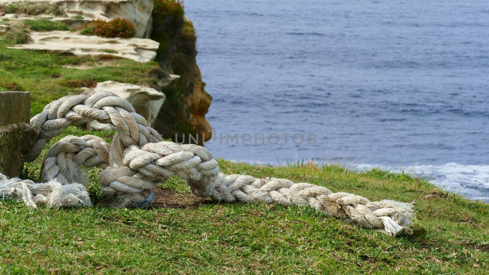 Boat mooring rope in a mountain on the coast of the Cantabrian Sea by XabiDonostia