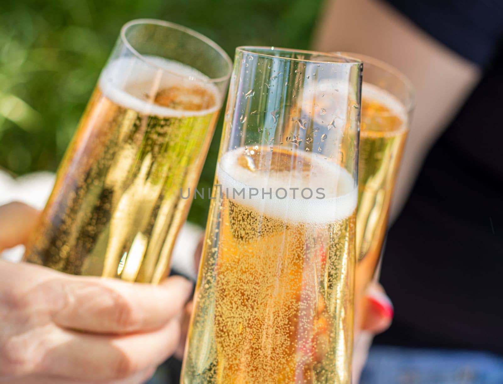 Close up view of a single flute glass of champagne outdoors by Suietska