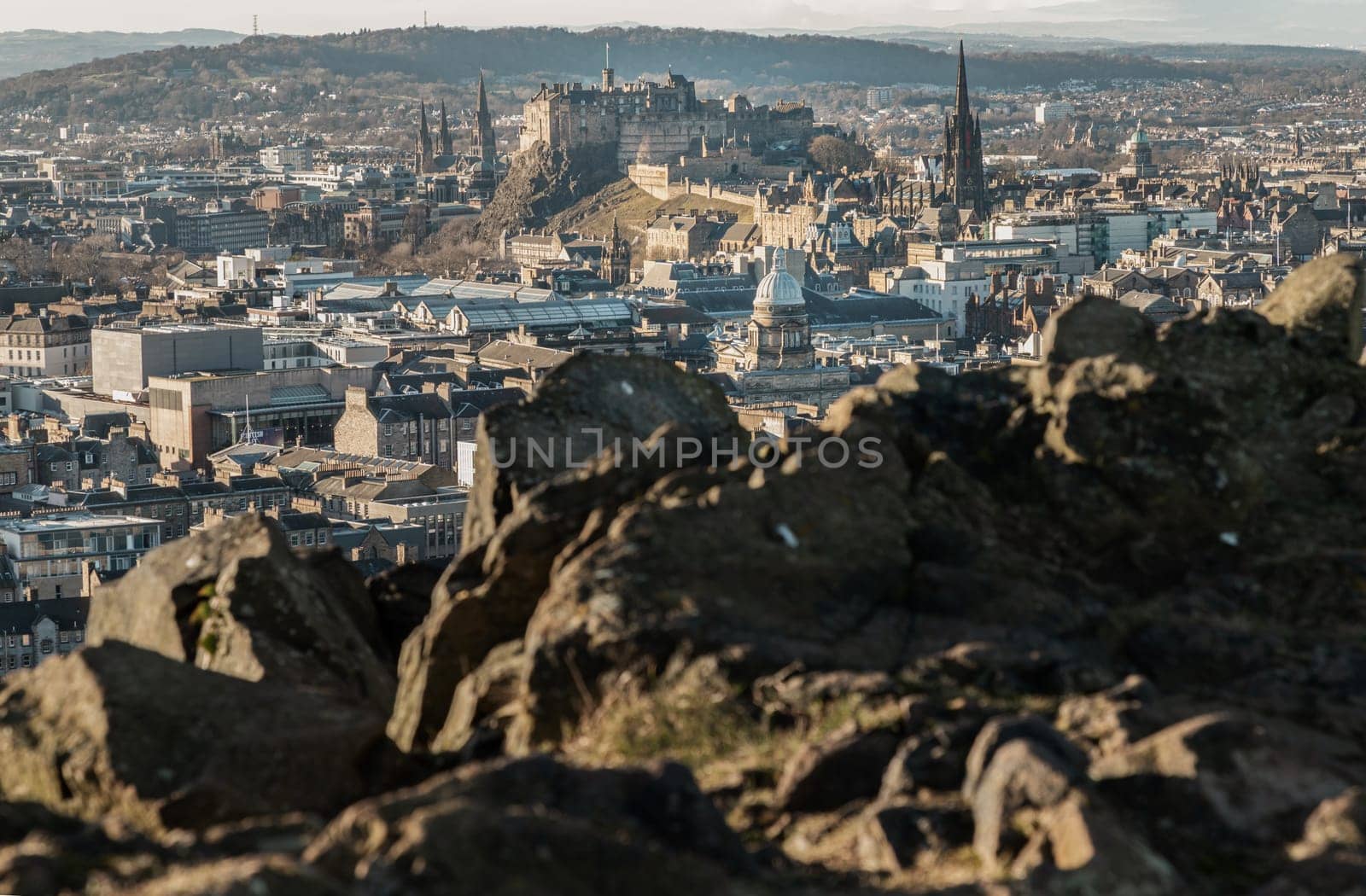 Edinburgh, Scotland - Jan 17, 2024 - Amazing Edinburgh Cityscape and Edinburgh Castle seen from the top of Salisbury Crags. Destinations in Europe, Copy space, Selective focus.